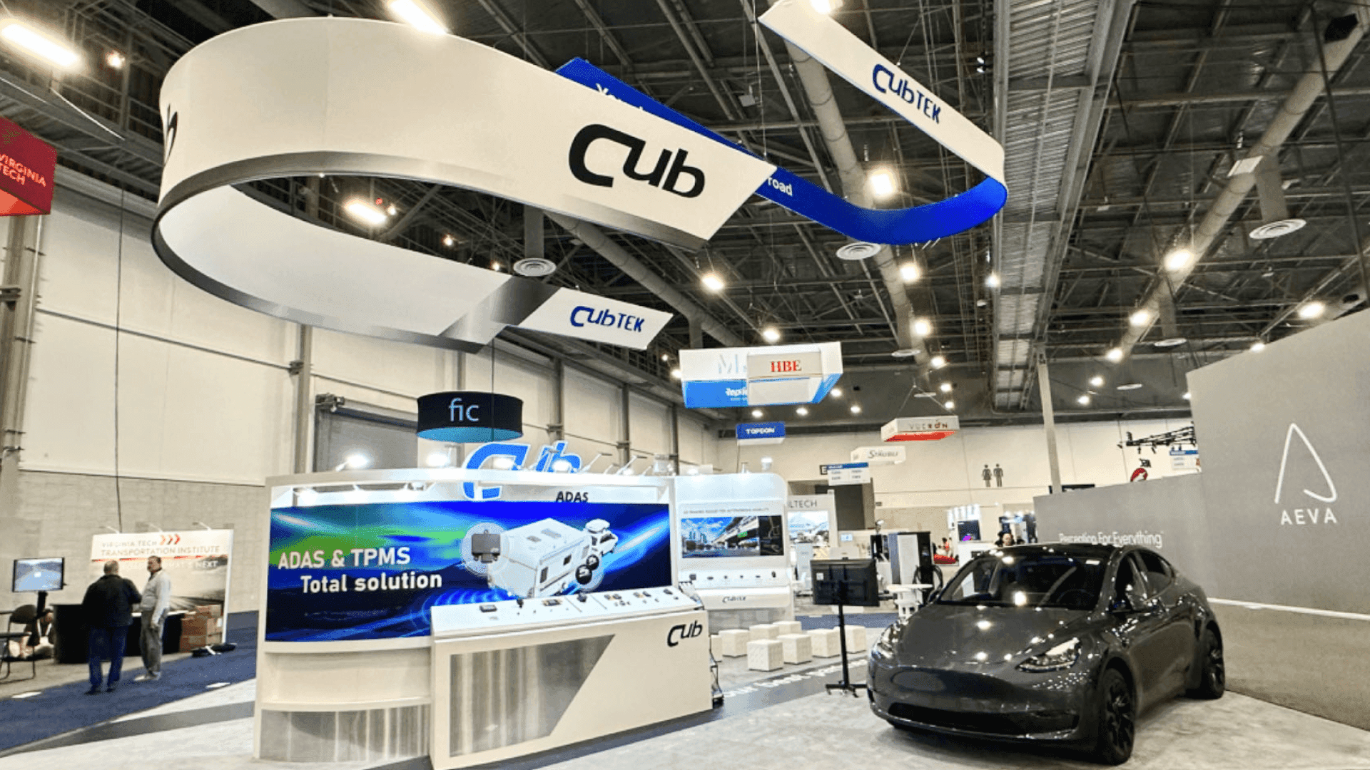 20x20 trade show booth for EV charging infrastructure with charging hardware display and open technical discussion layout