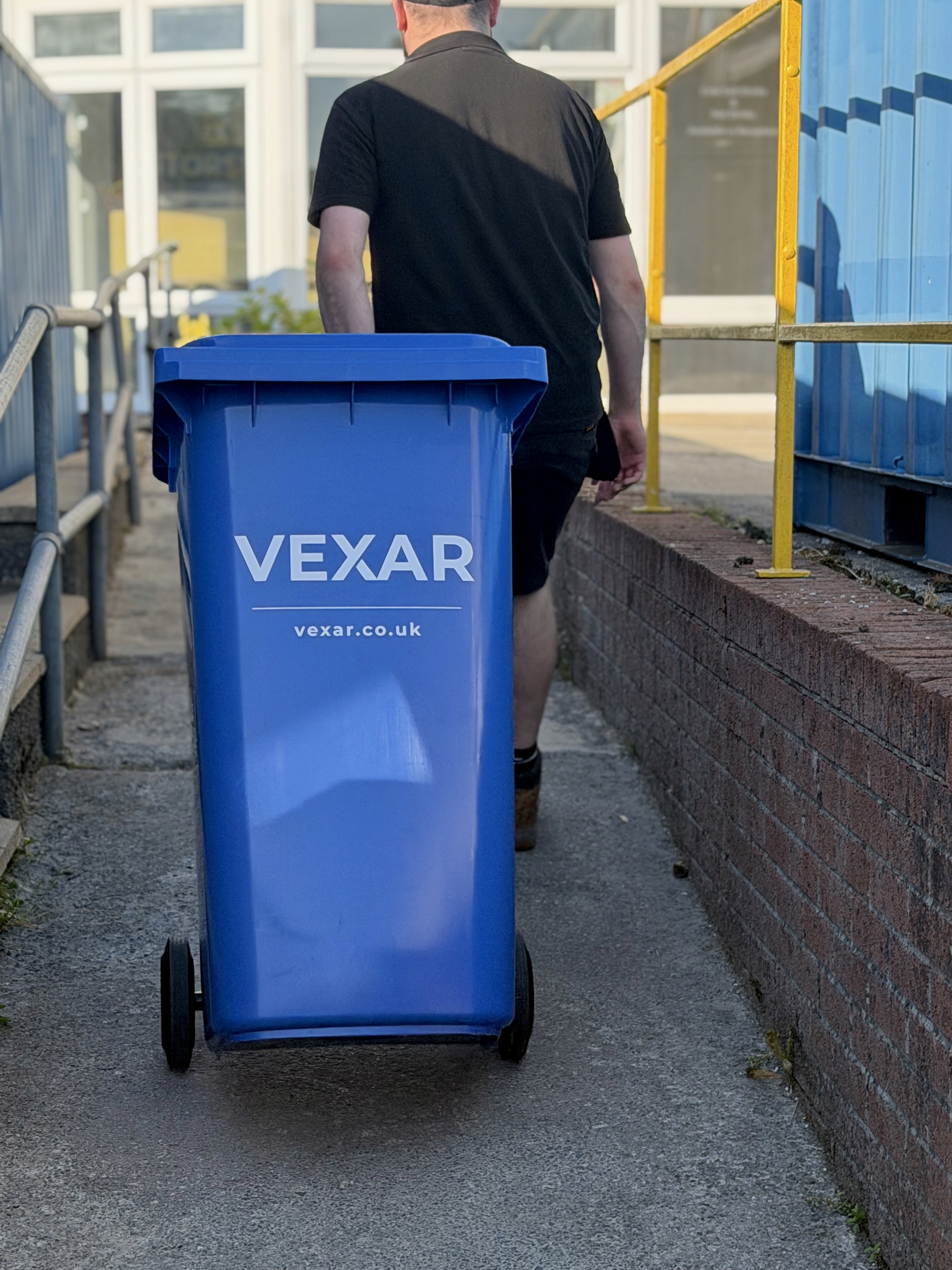 VEXAR team member moving a customer wheelie bin