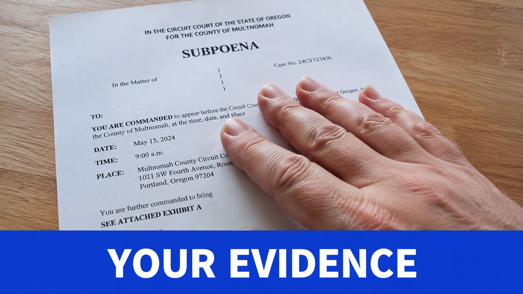 A hand rests on a legal subpoena document from Multnomah County Circuit Court in Oregon.