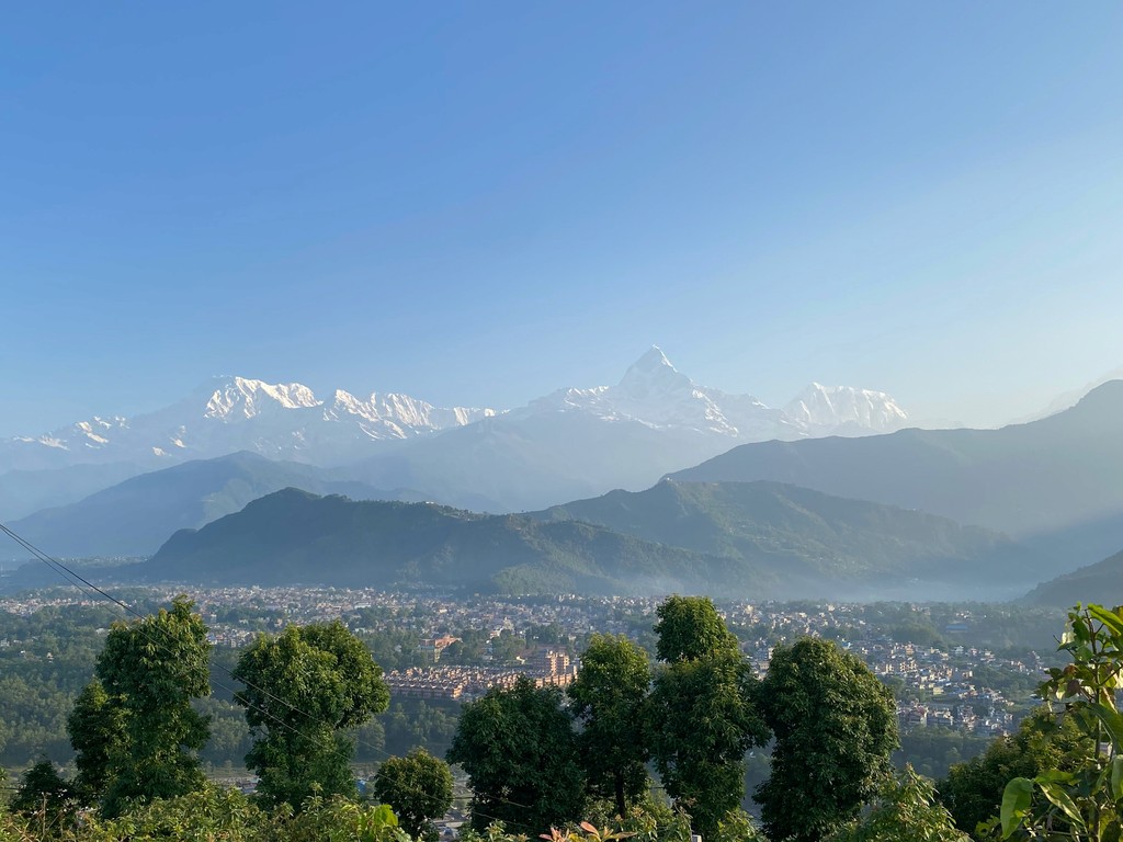 a view of a city and mountains from a distance