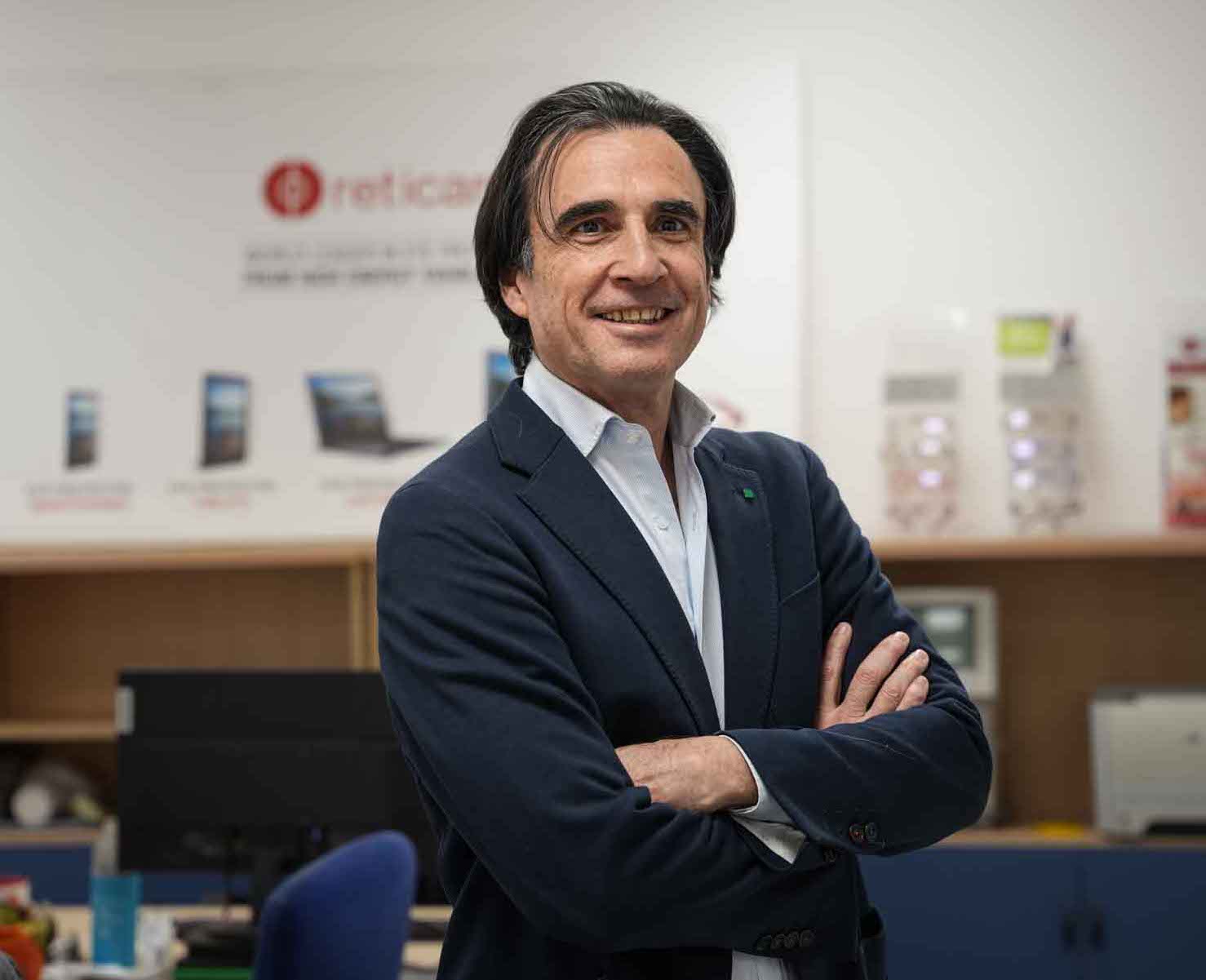 Stylish woman wearing an oversized cream quarter-zip sweatshirt and large sunglasses, looking to the side against a peach-colored wall.