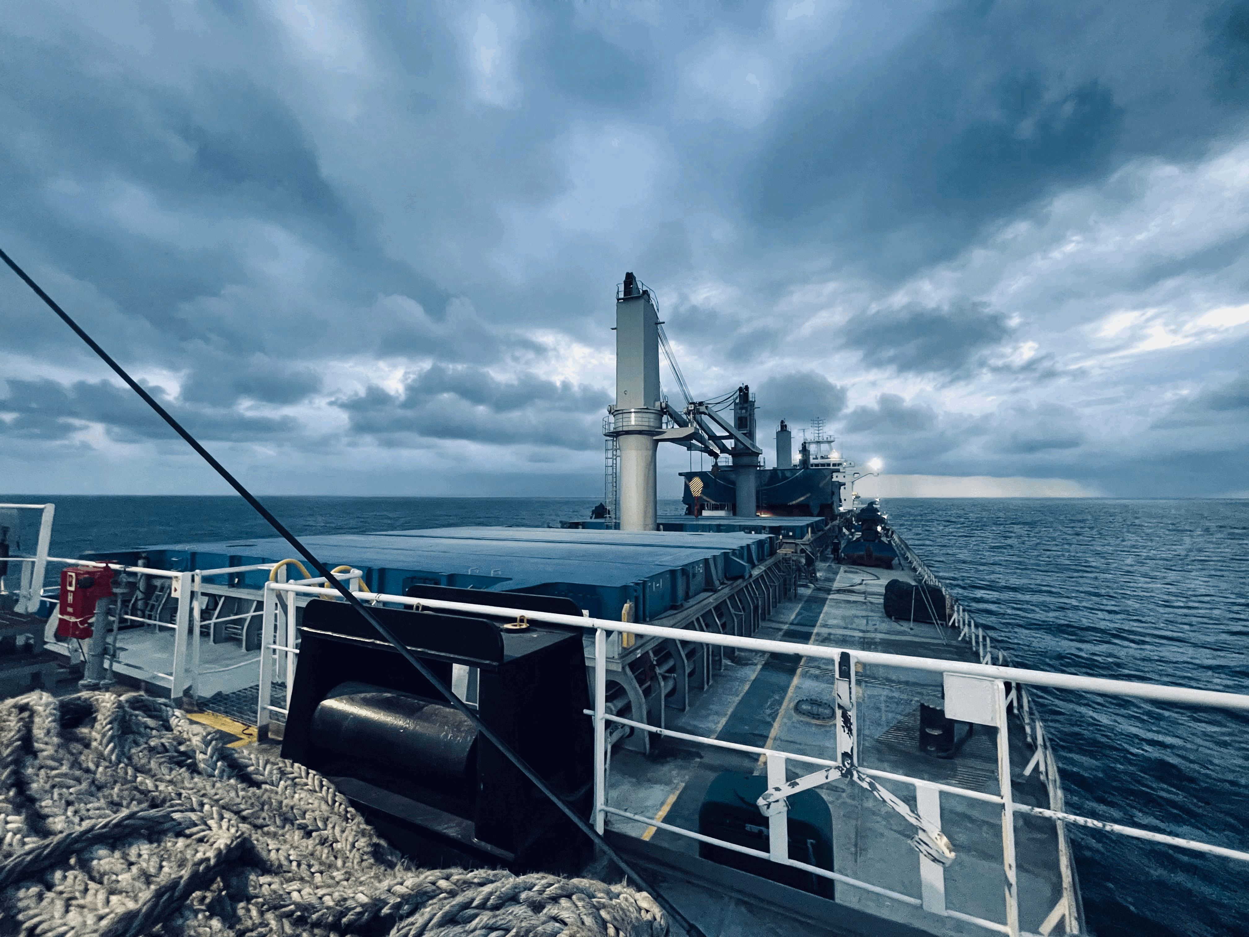 M/V Falcon Trader at Pecém anchorage during cargo hold cleaning operations, with deck condition captured ahead of a follow-on condition survey.