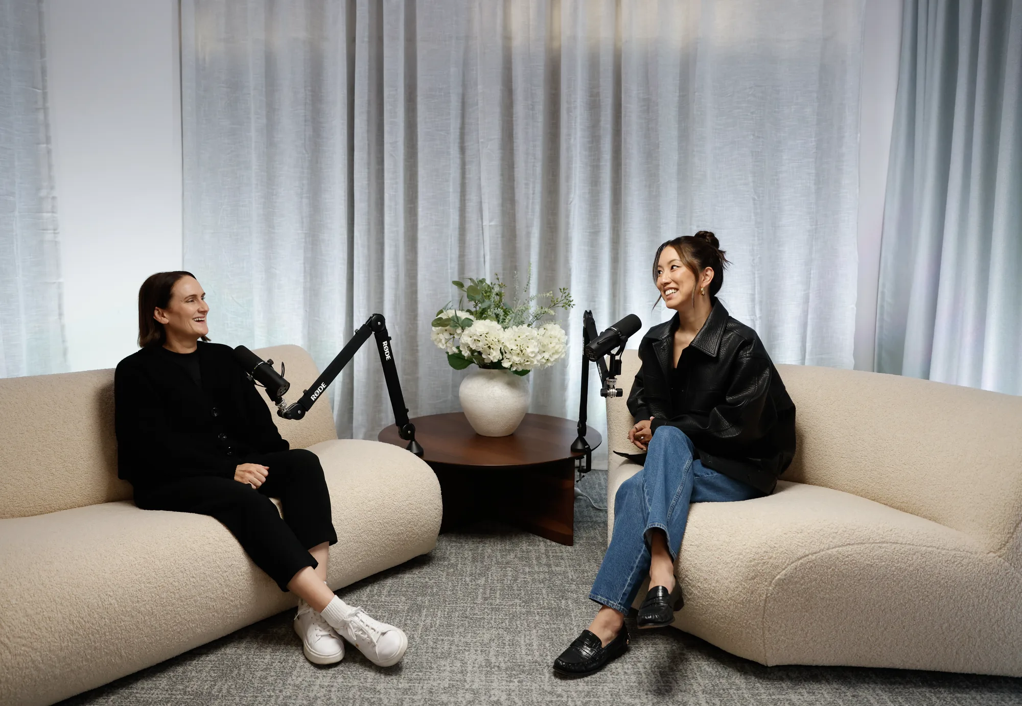 A guest seated on the bouclé sofa at the microphone in the RESIDENCE lounge