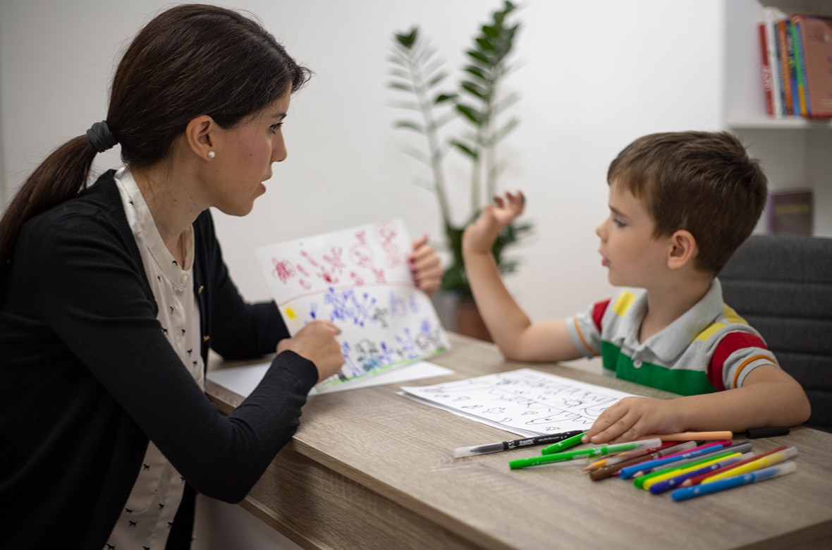 Child interacting with therapist during structured counseling session
