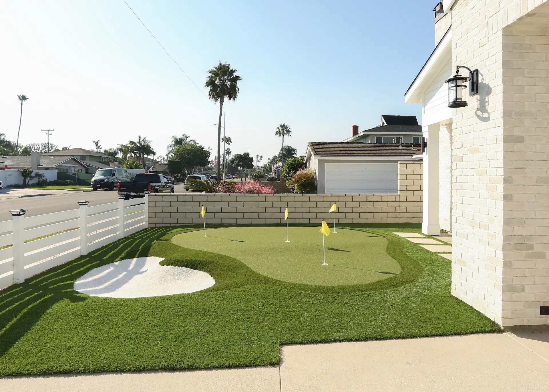 View of front yard putting green with sand trap. Photo by Chris Darnall.