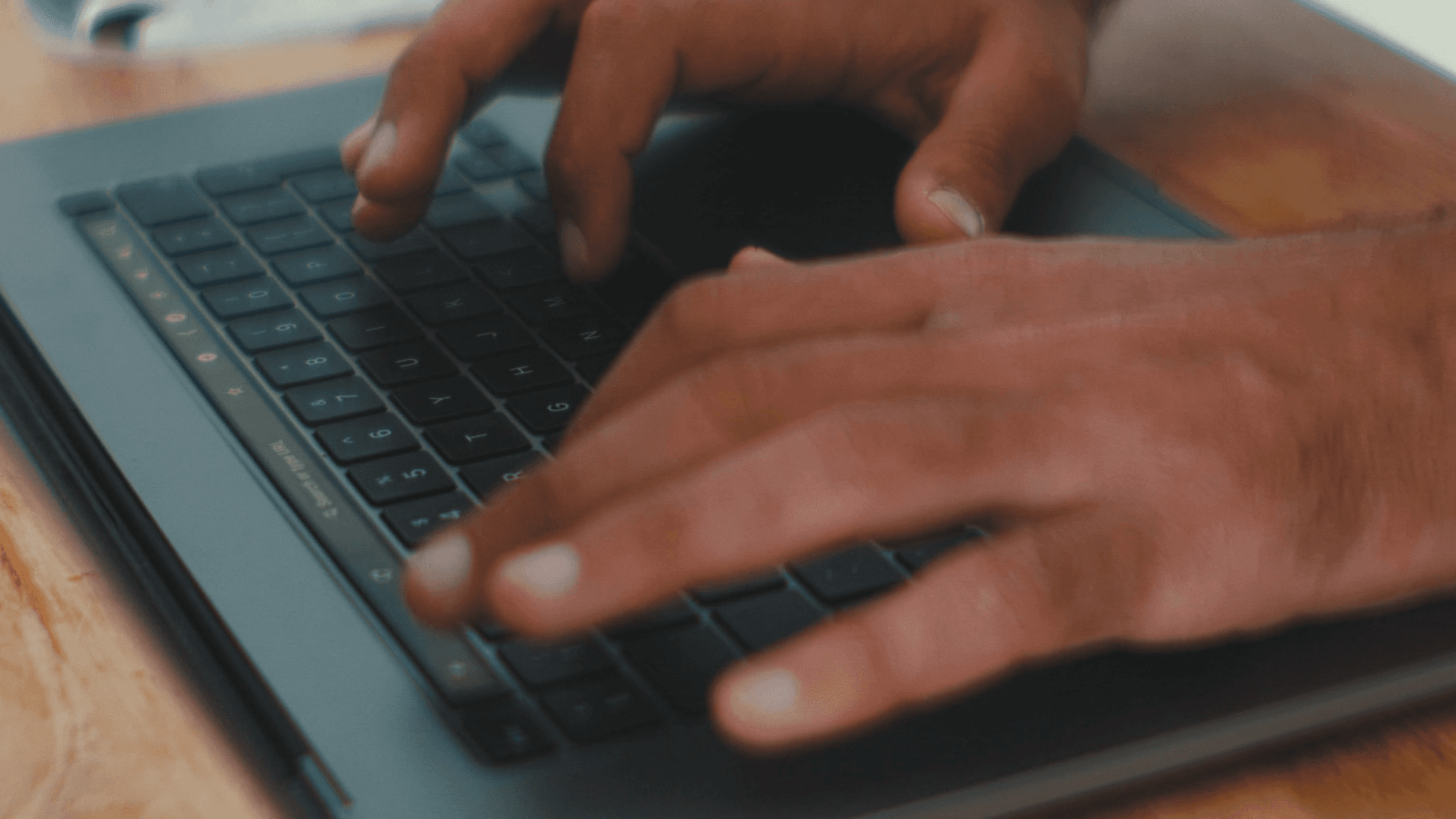 Person typing on a computer.