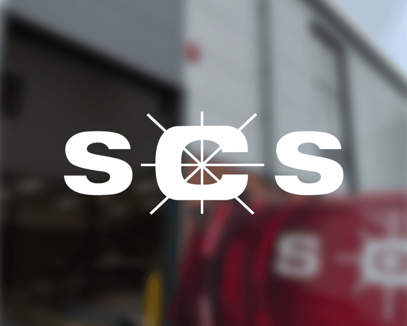 man wearing black and teal dress suit standing near gray wall