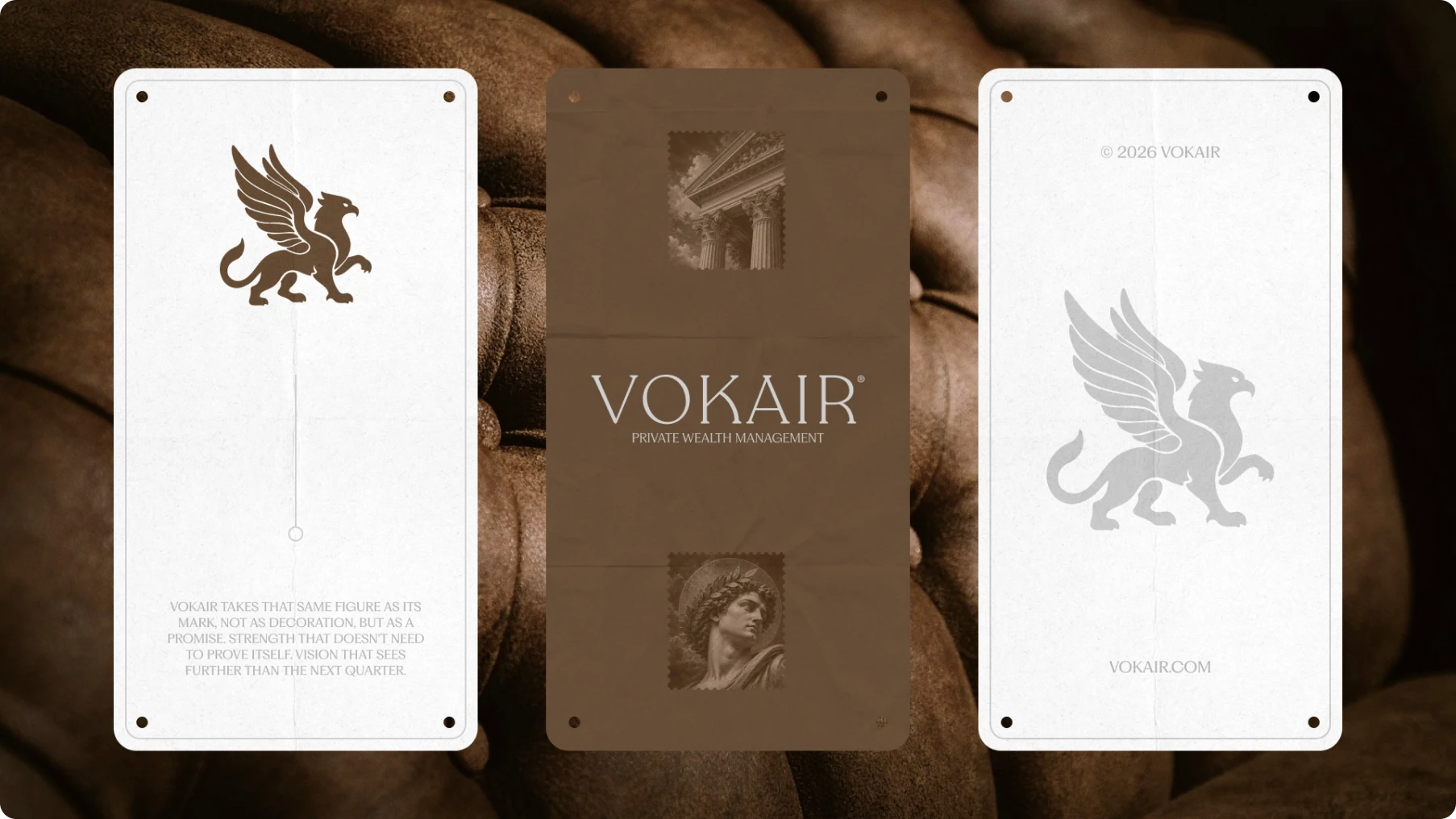 Three Vokair private wealth management cards with griffin logos rest on brown tufted leather, conveying an elegant, luxurious, professional tone.
