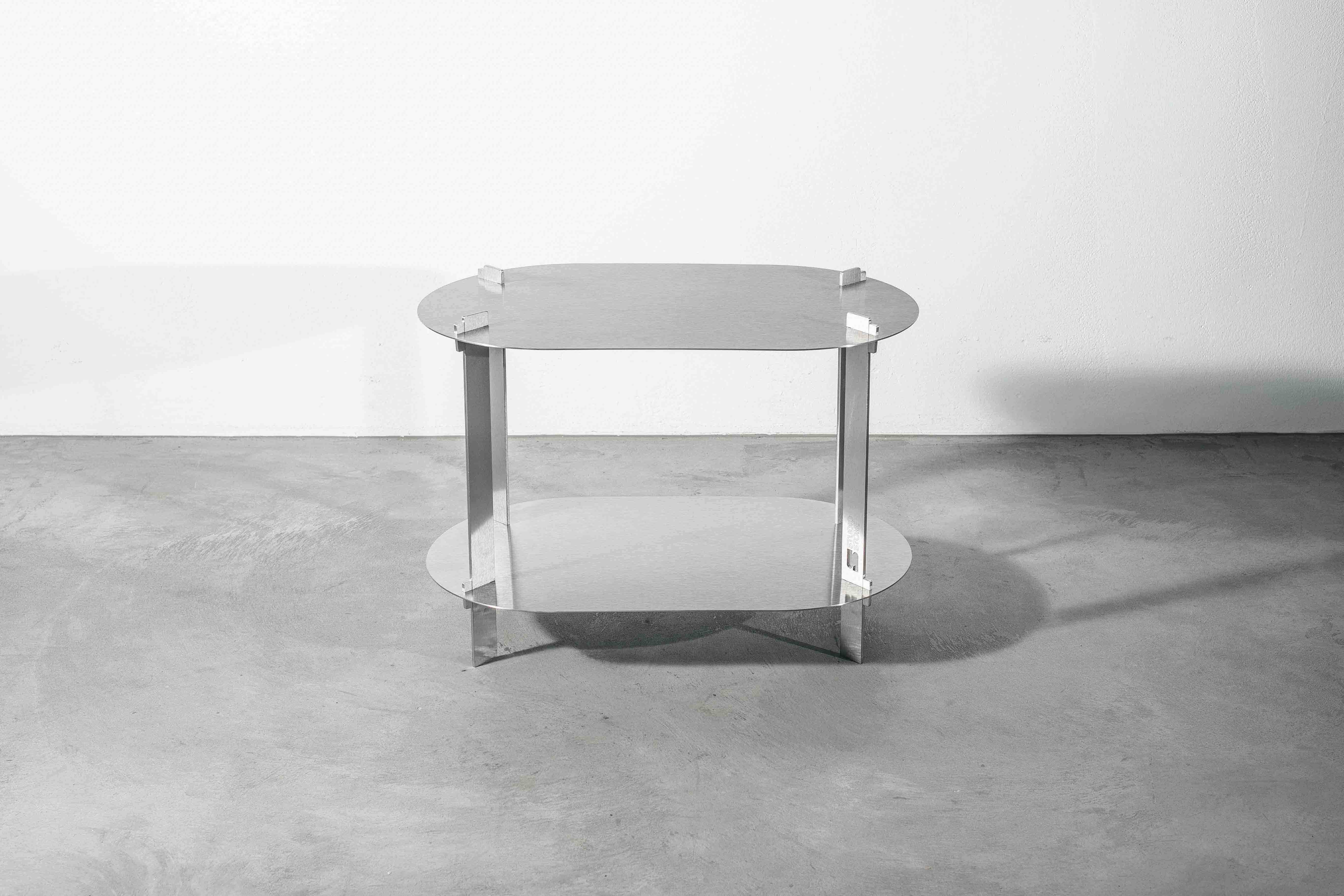 a metal designer table on a concrete floor