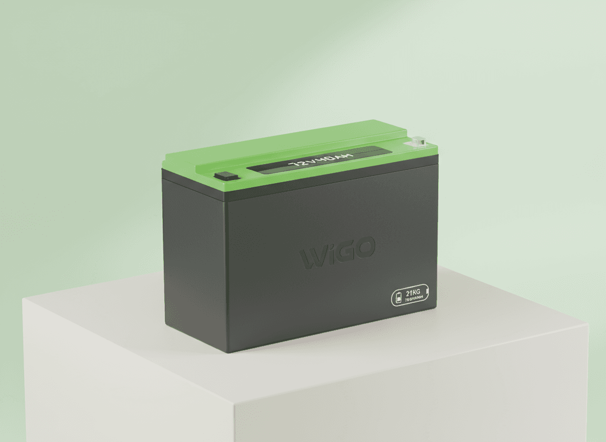 Focused woman working on a laptop in a cozy, dimly lit café with a tea glass on the table.