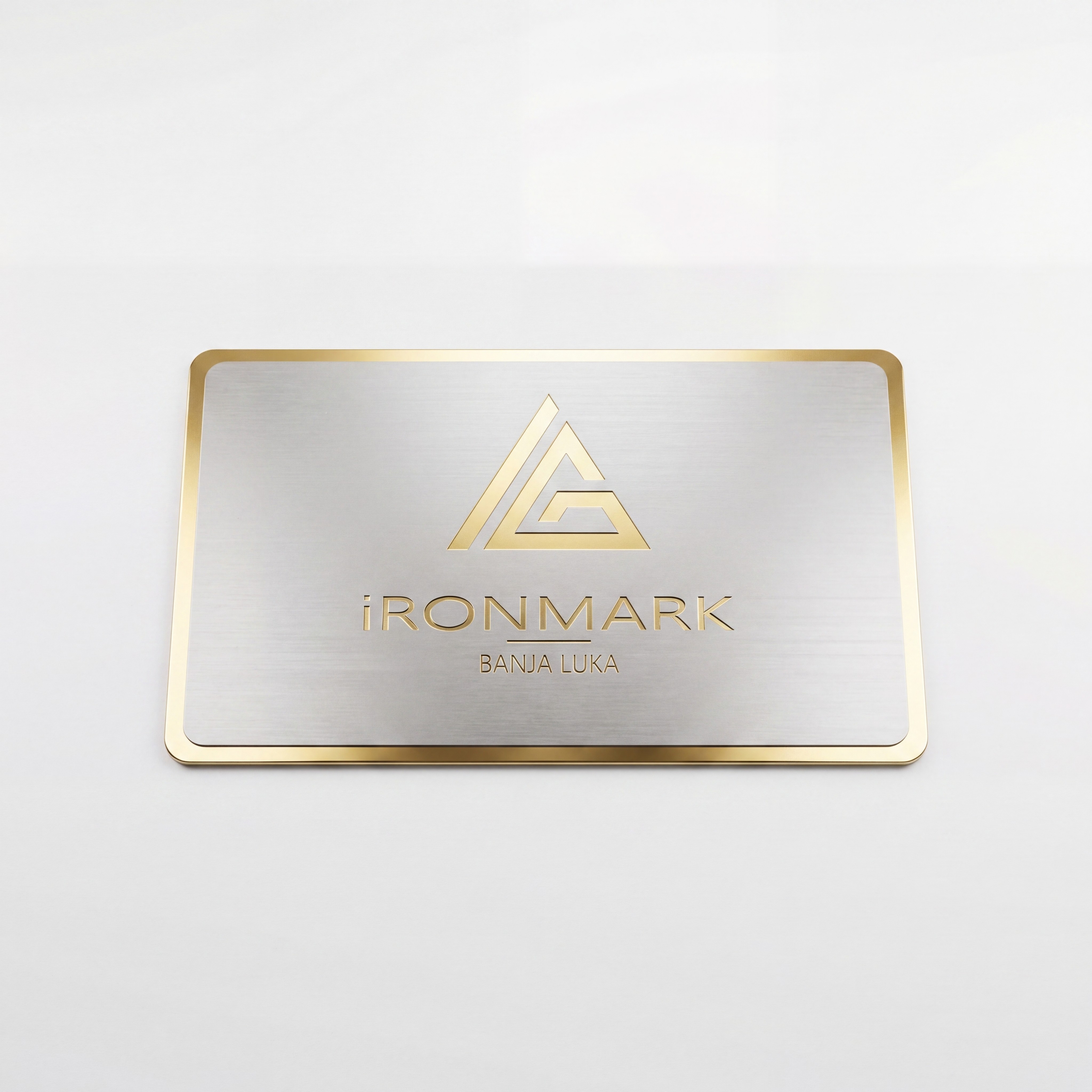 A dark glass bottle with a pump sits on a stone, surrounded by green leaves and textured background.