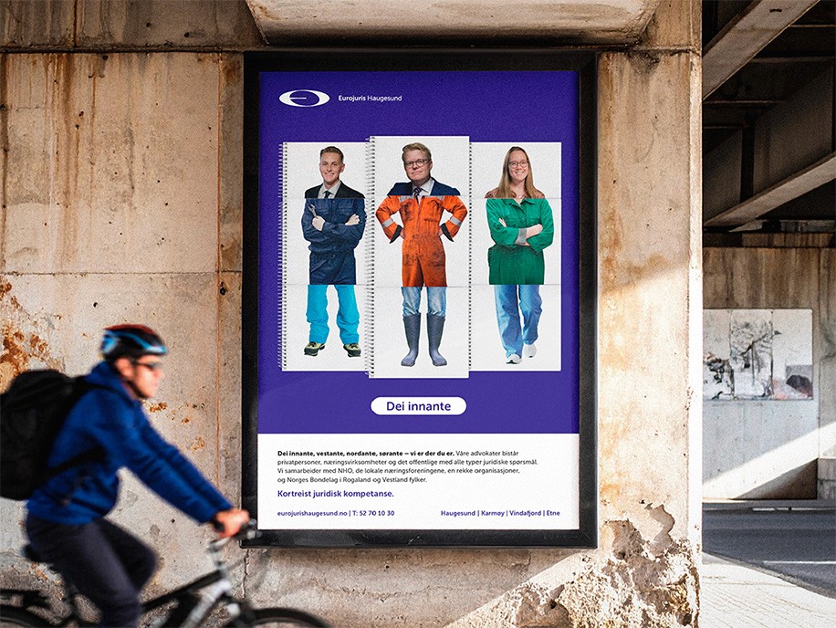 Kampanjeplakat i urbant miljø med mann som sykler forbi