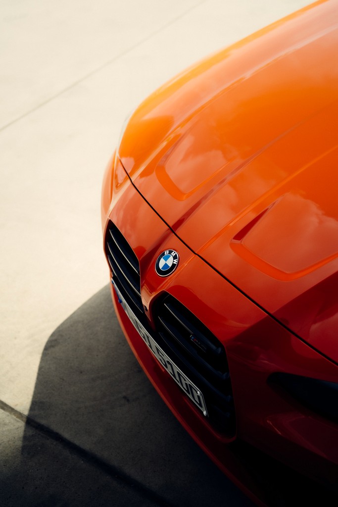 Orange BMW M3 G80 parked