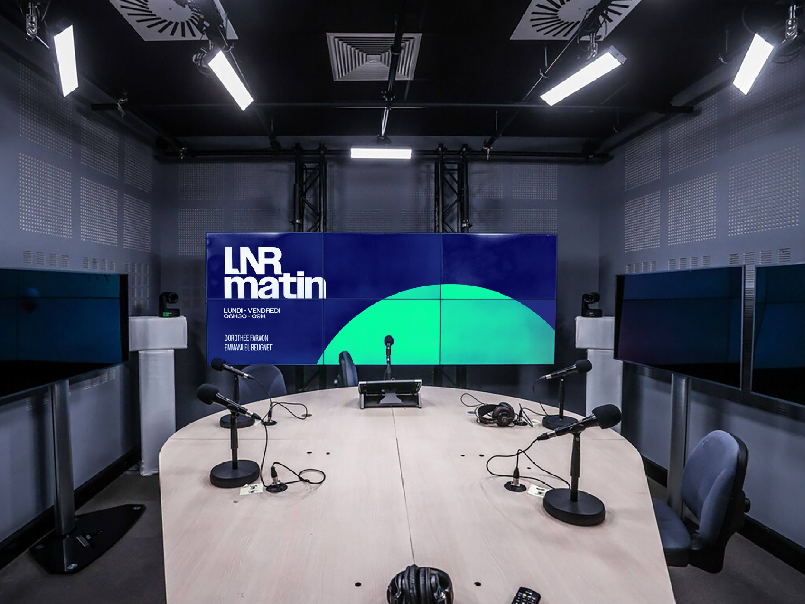 Modern home office setup with a monitor, ergonomic chair, keyboard, and indoor plants near a window with blinds.