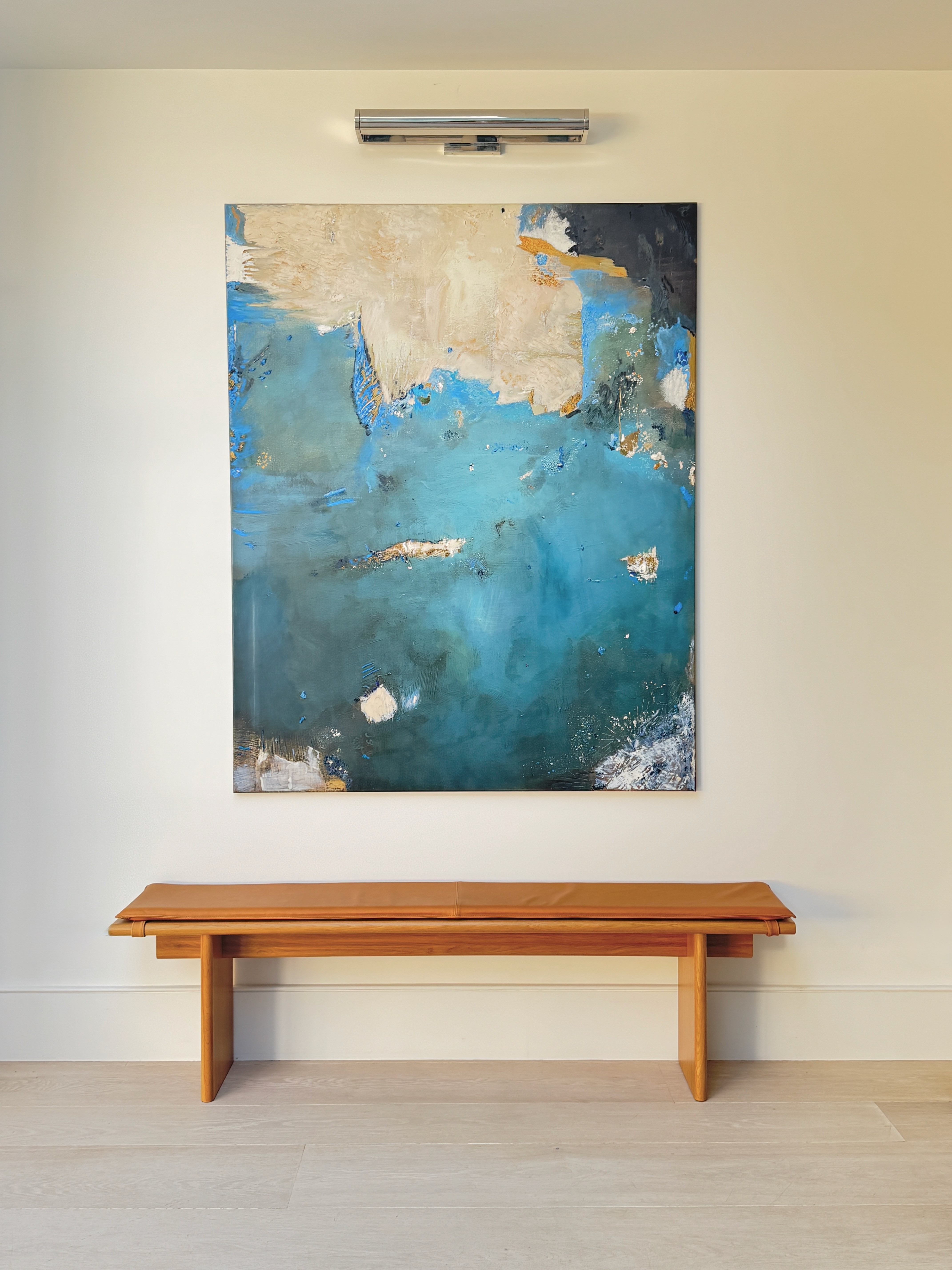 gray padded chaise couch beside window