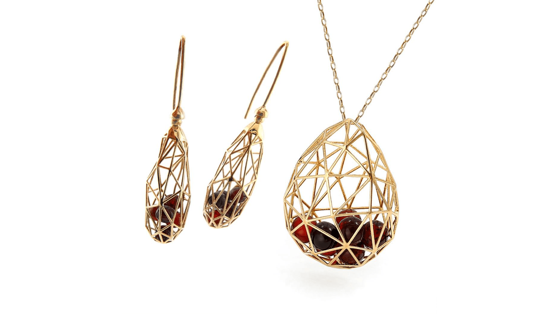 Elegant gold geometric-patterned jewelry set featuring a pair of drop earrings and a matching pendant necklace on a delicate chain, displayed against a white background.