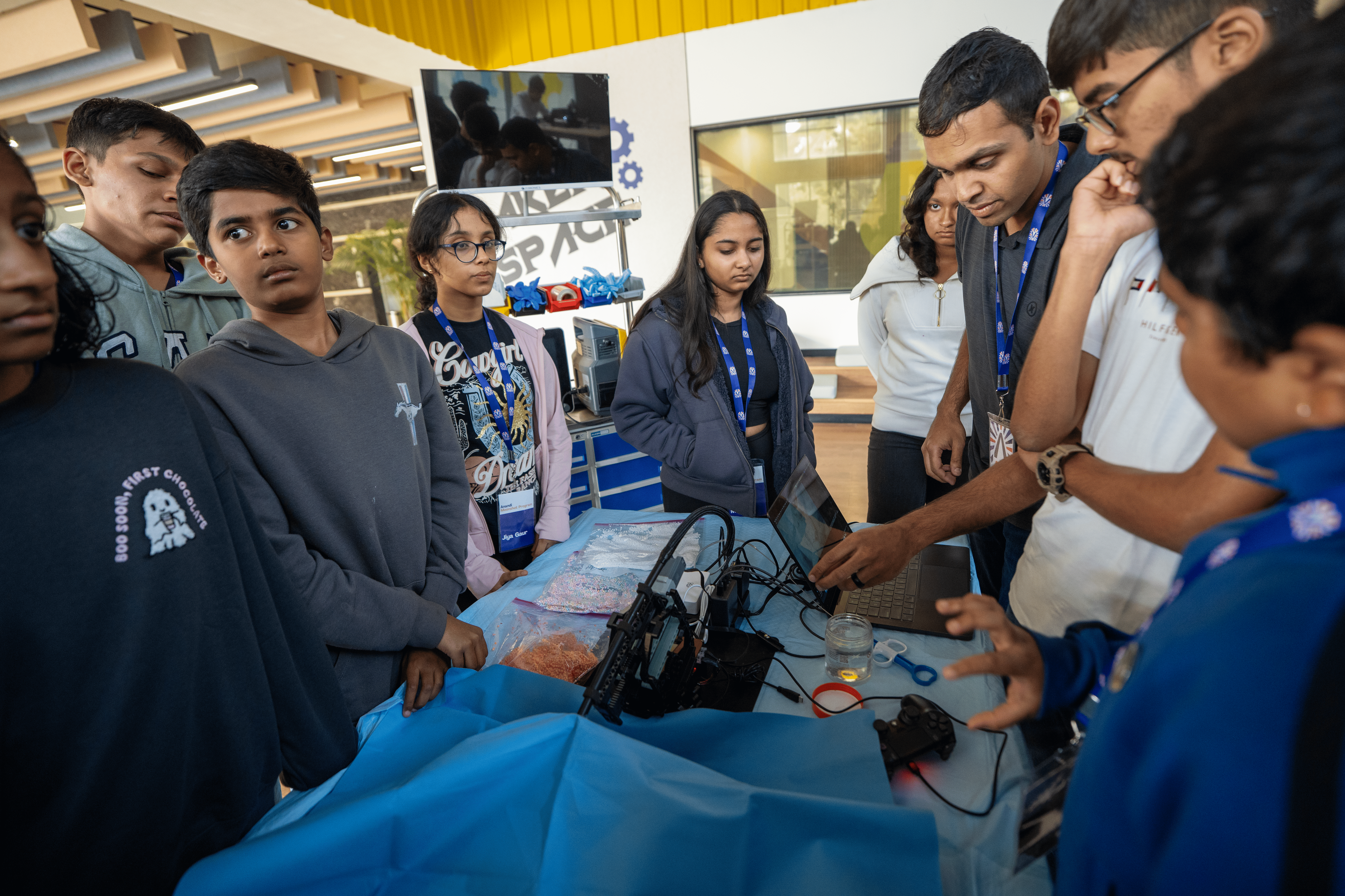 Group of students exploring robotics project in STEM workshop