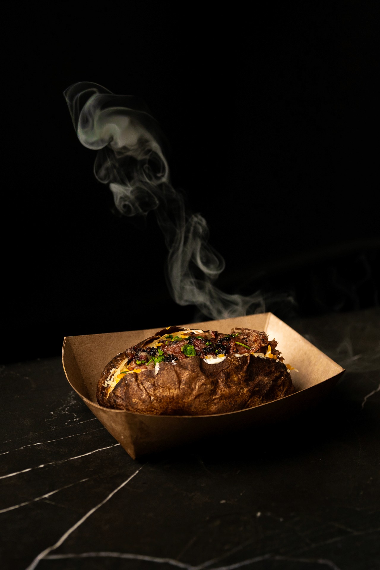 food photography of a smoked baked potato