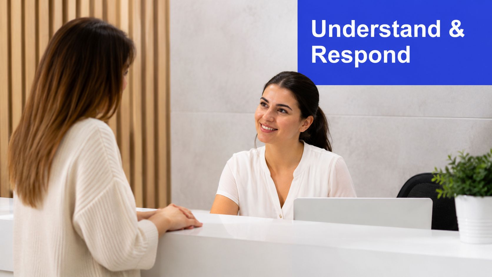 A friendly receptionist smiling and interacting with a patient at a modern medical office front desk.