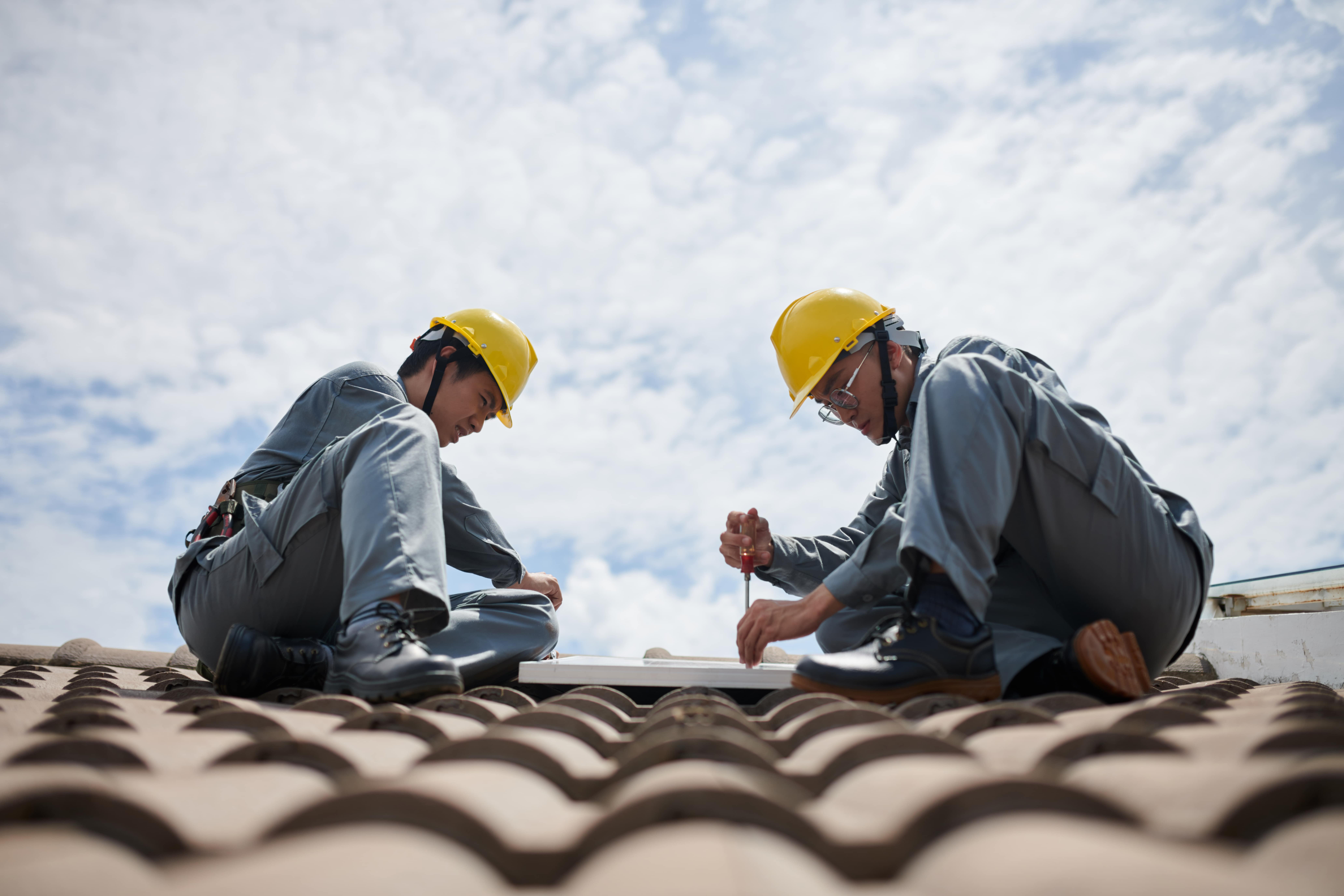 Roofing experts discussing repair vs. replacement options for Texas homes