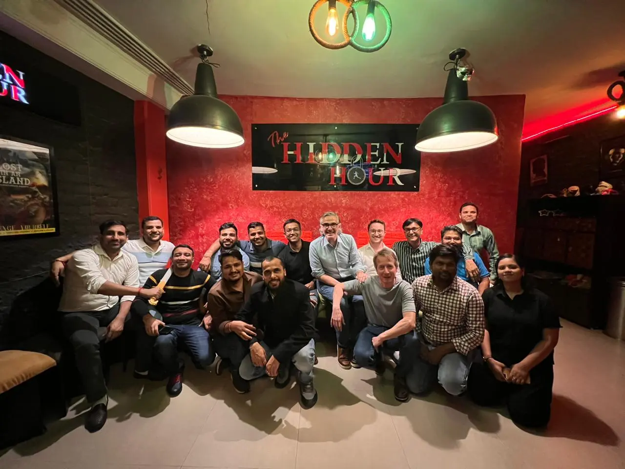 Corporate team posing after a successful escape room challenge at Hidden Hour Delhi