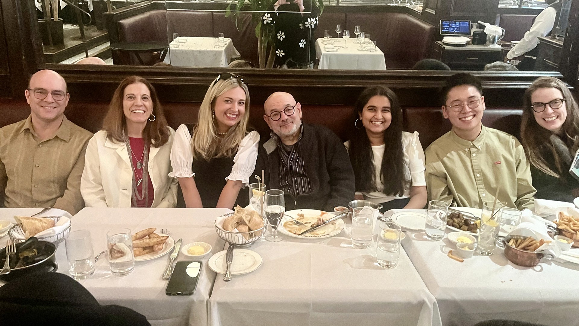 four alumni at a restaurant with the co-chairs (and one other random guy)