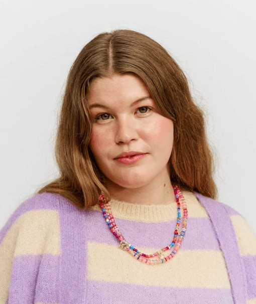 Close-up of a dark green leaf showing its textured surface and central vein against a muted background.