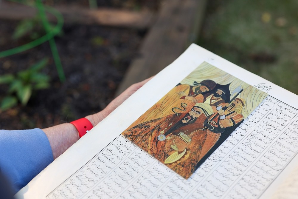 Bubjan with book and speaking to camera