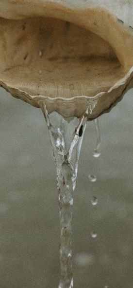 A man playing a drum in front of a group of people