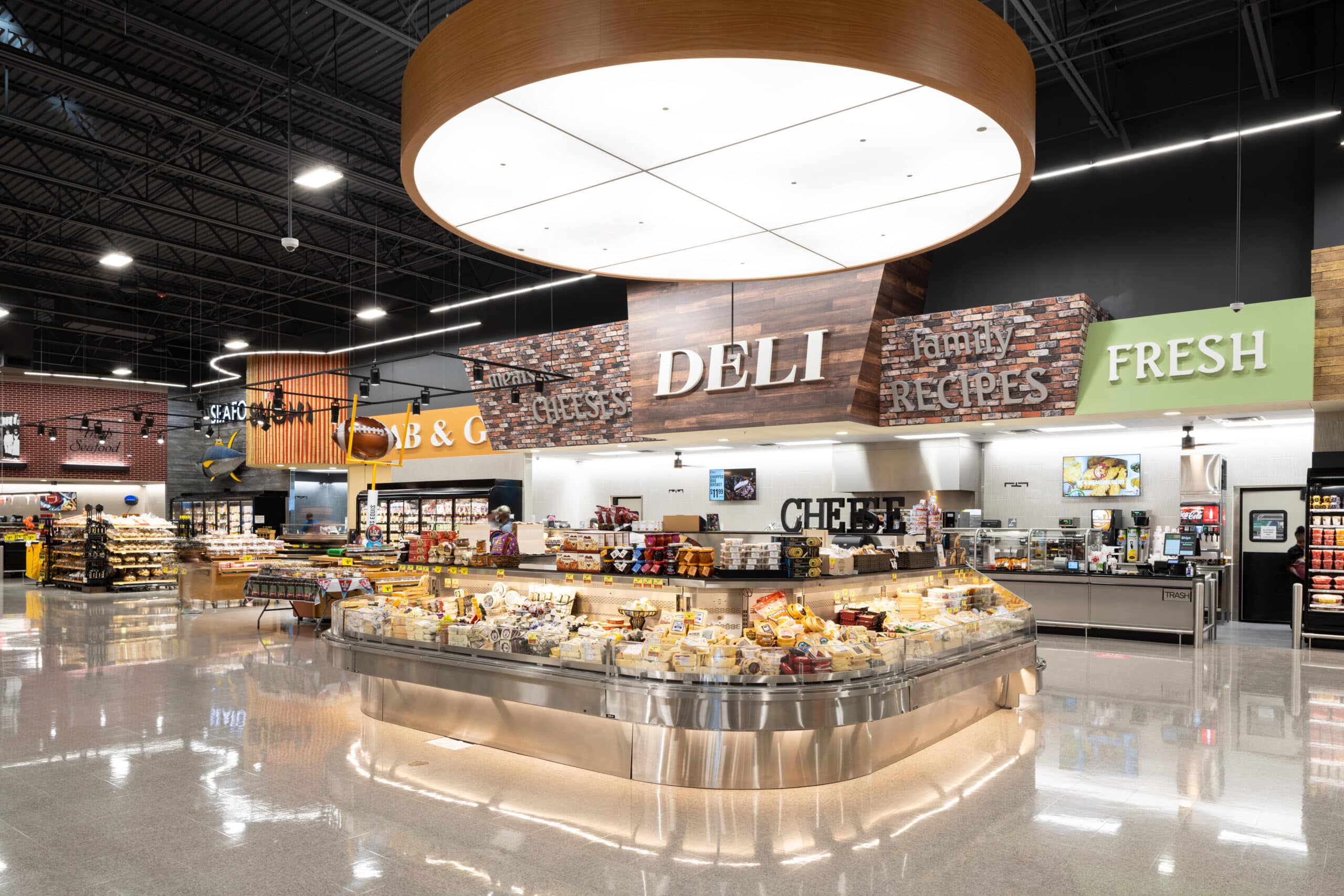 Retail buyers reviewing Panamia empanadas and chimichurri in a bright deli