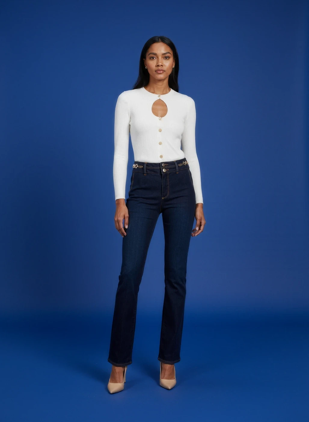 AI-generated fashion model wearing white keyhole cardigan and dark blue jeans on blue background