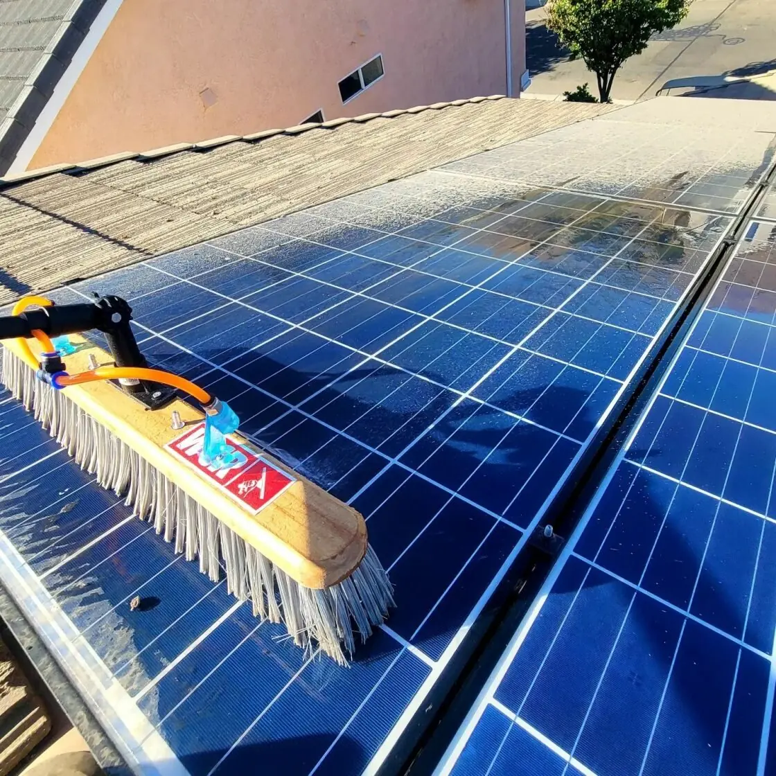 Soft hand brush with soap washing residential solar panels | Premier Solar Service, serving Fresno, CA