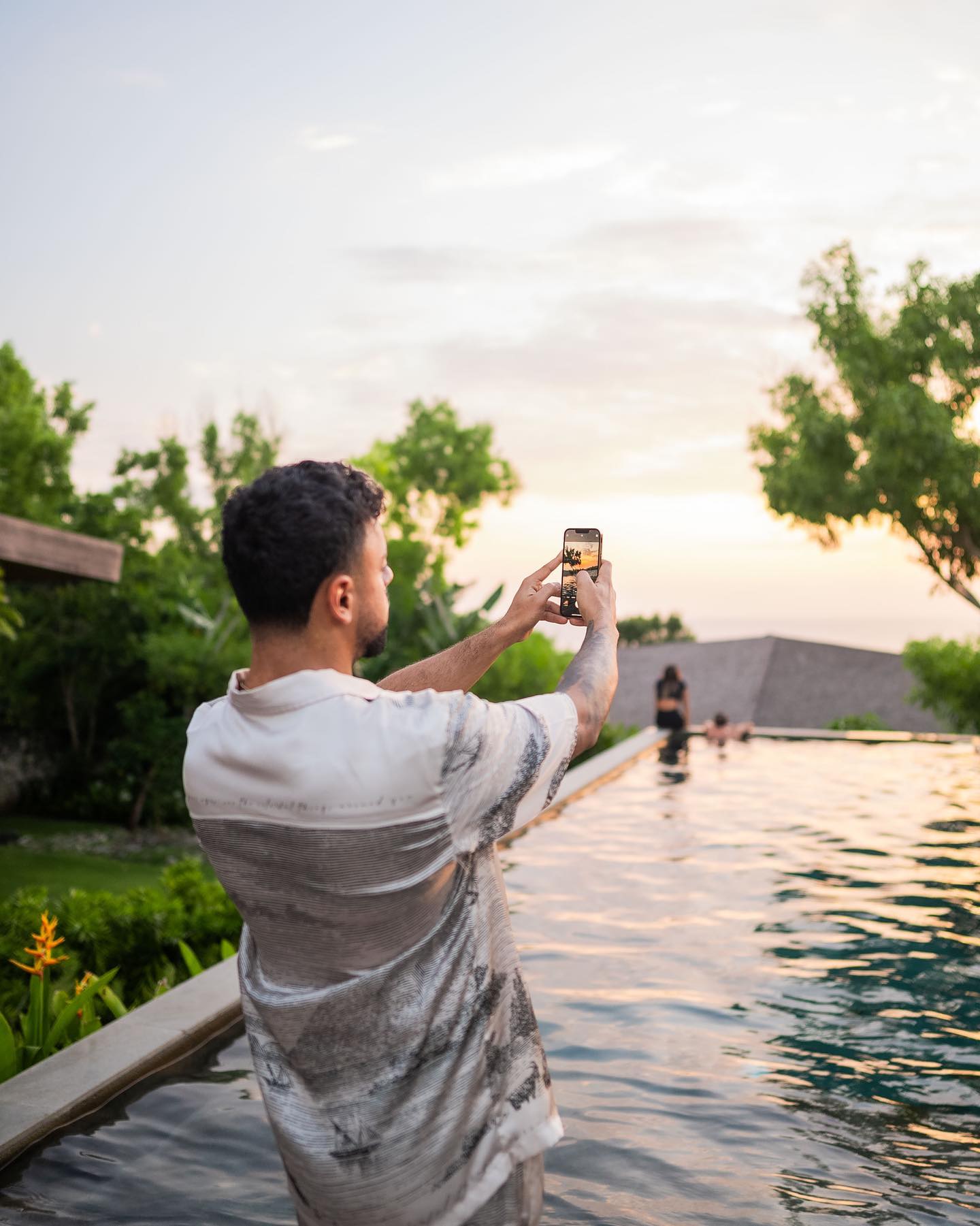 a woman holding a red flower