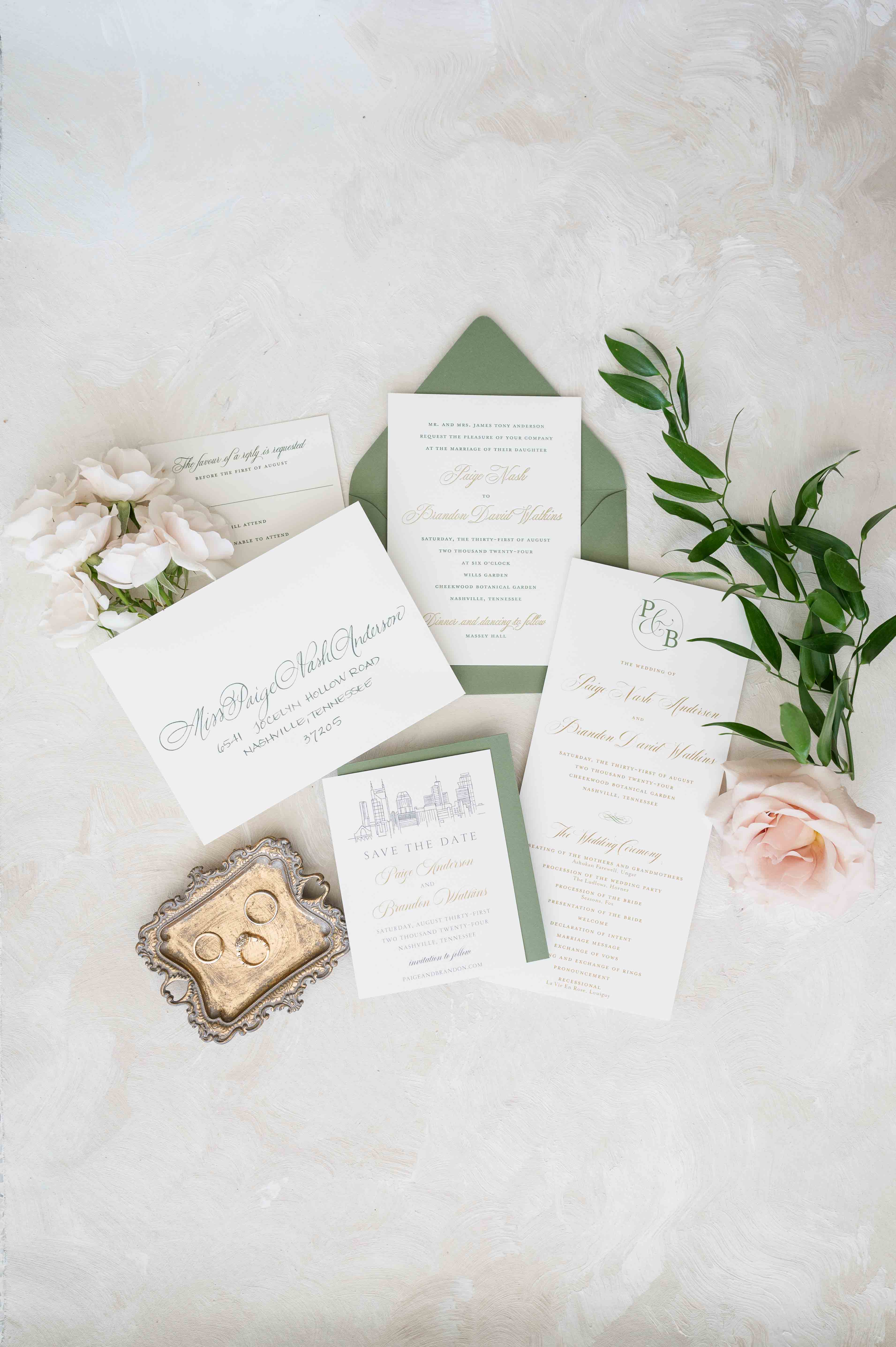 Flat lay of wedding invitation suite with fresh florals.
