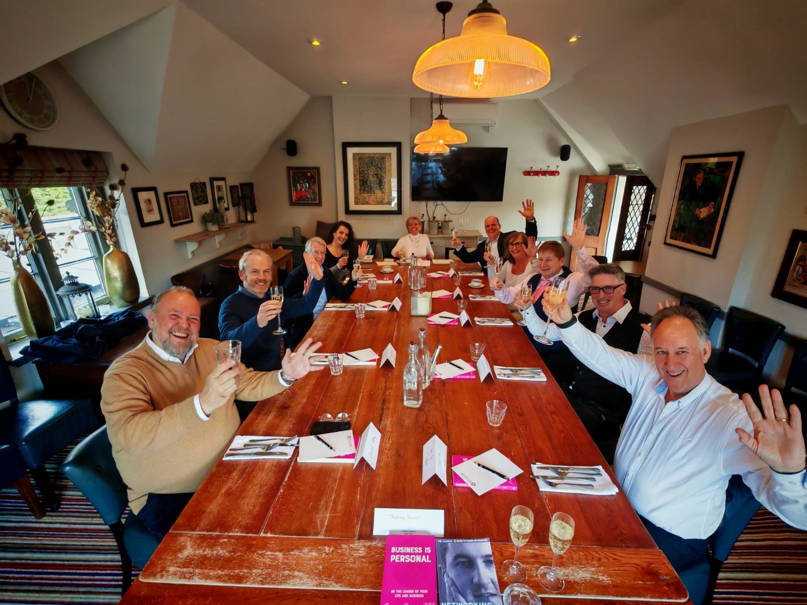 Woman sitting in sunlight with eyes closed, wearing relaxed neutral clothing in a peaceful setting.