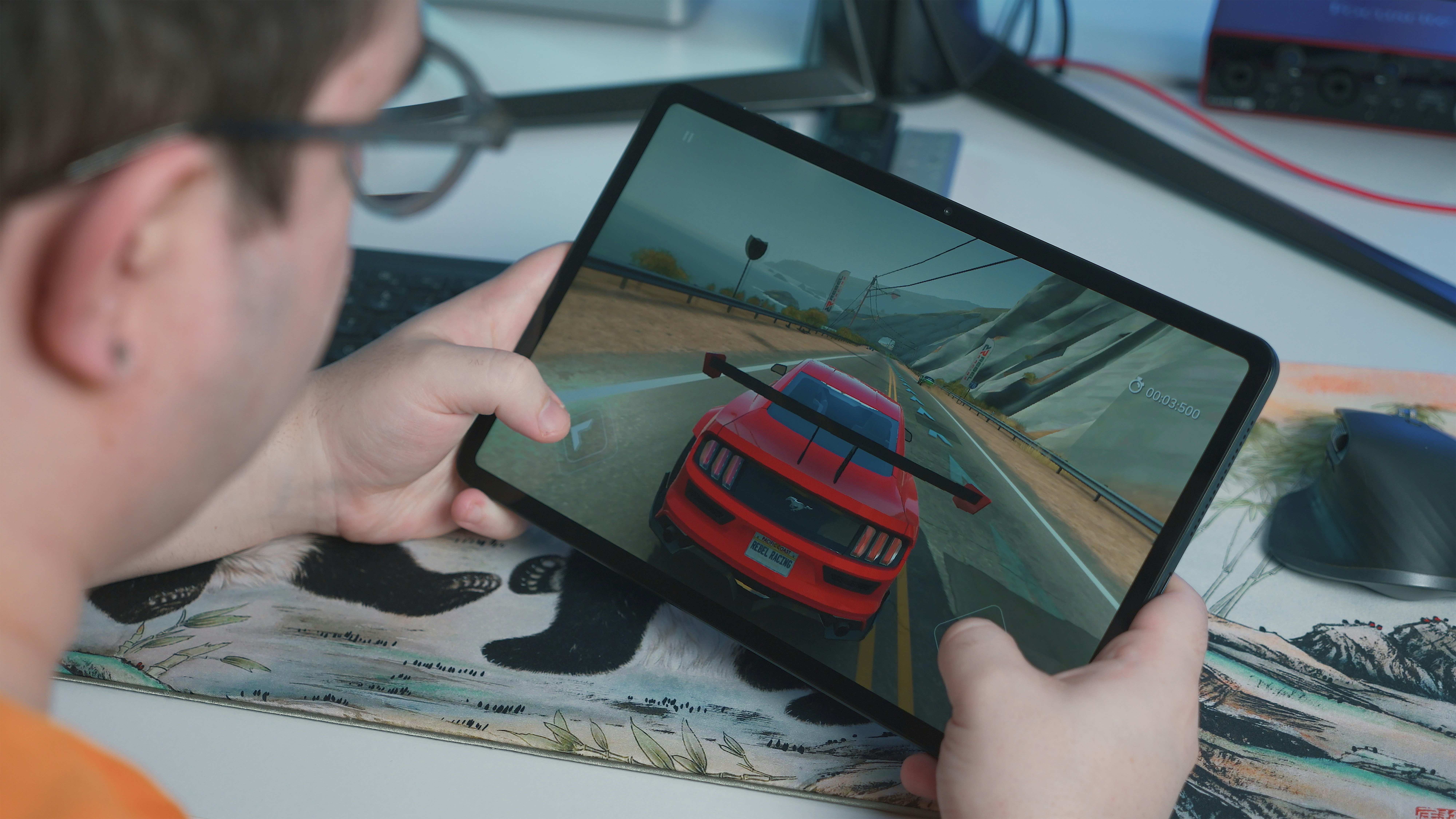 Man playing driving simulation game on a tablet computer