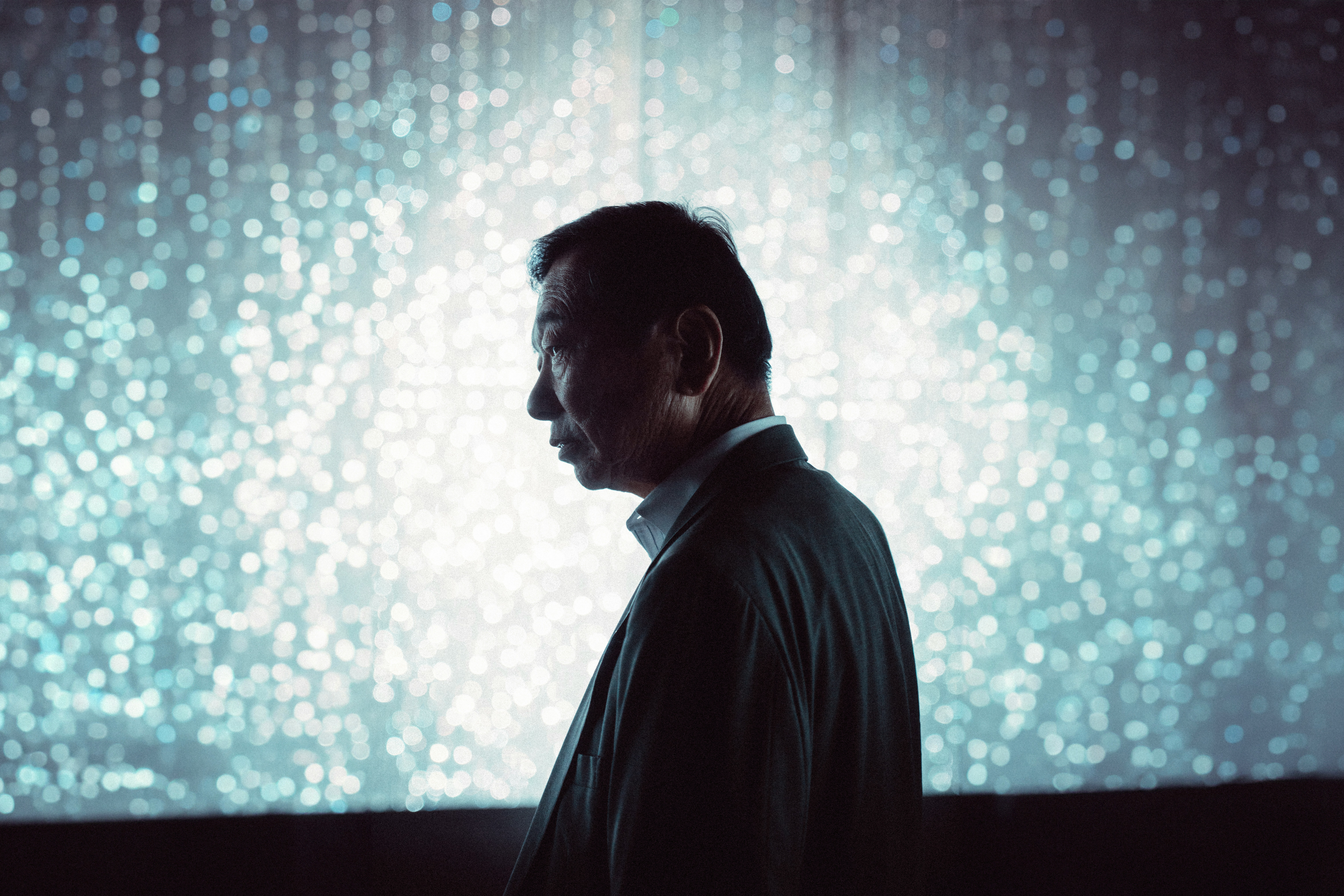 A man standing in front of a large screen