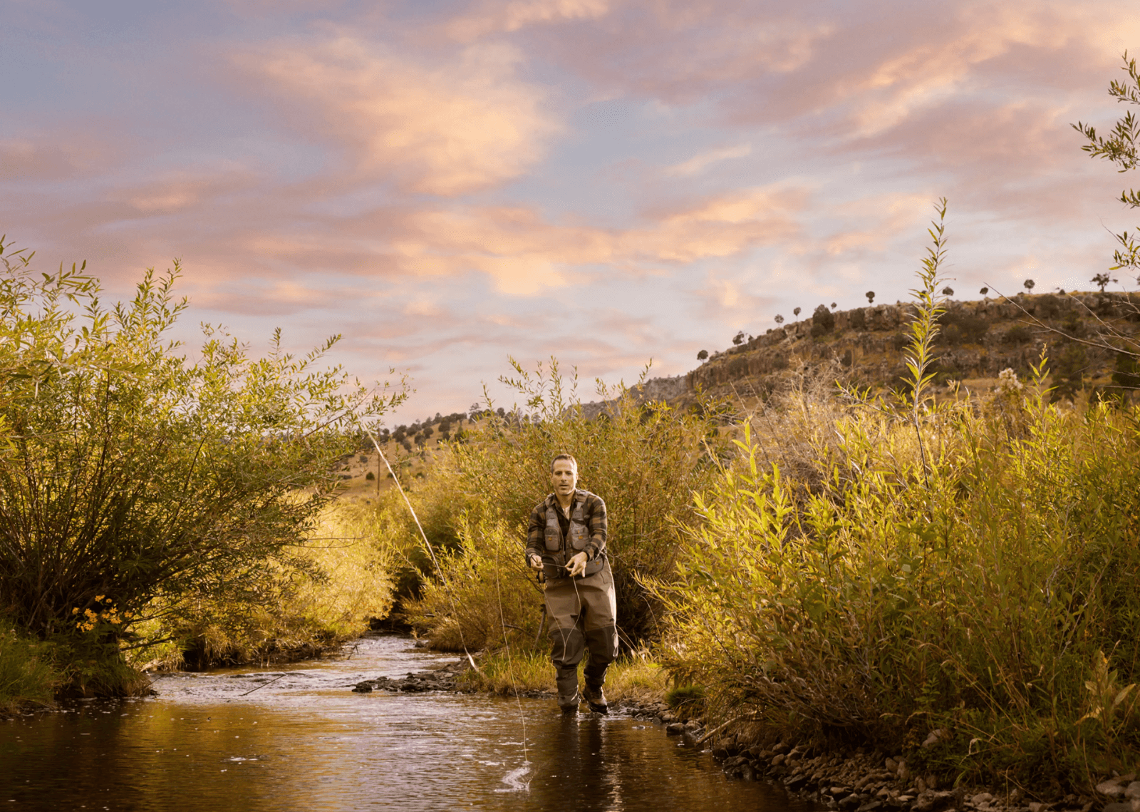 Fly fisherman wading a river at golden hour, Arizona Office of Tourism commercial still by Inquire
