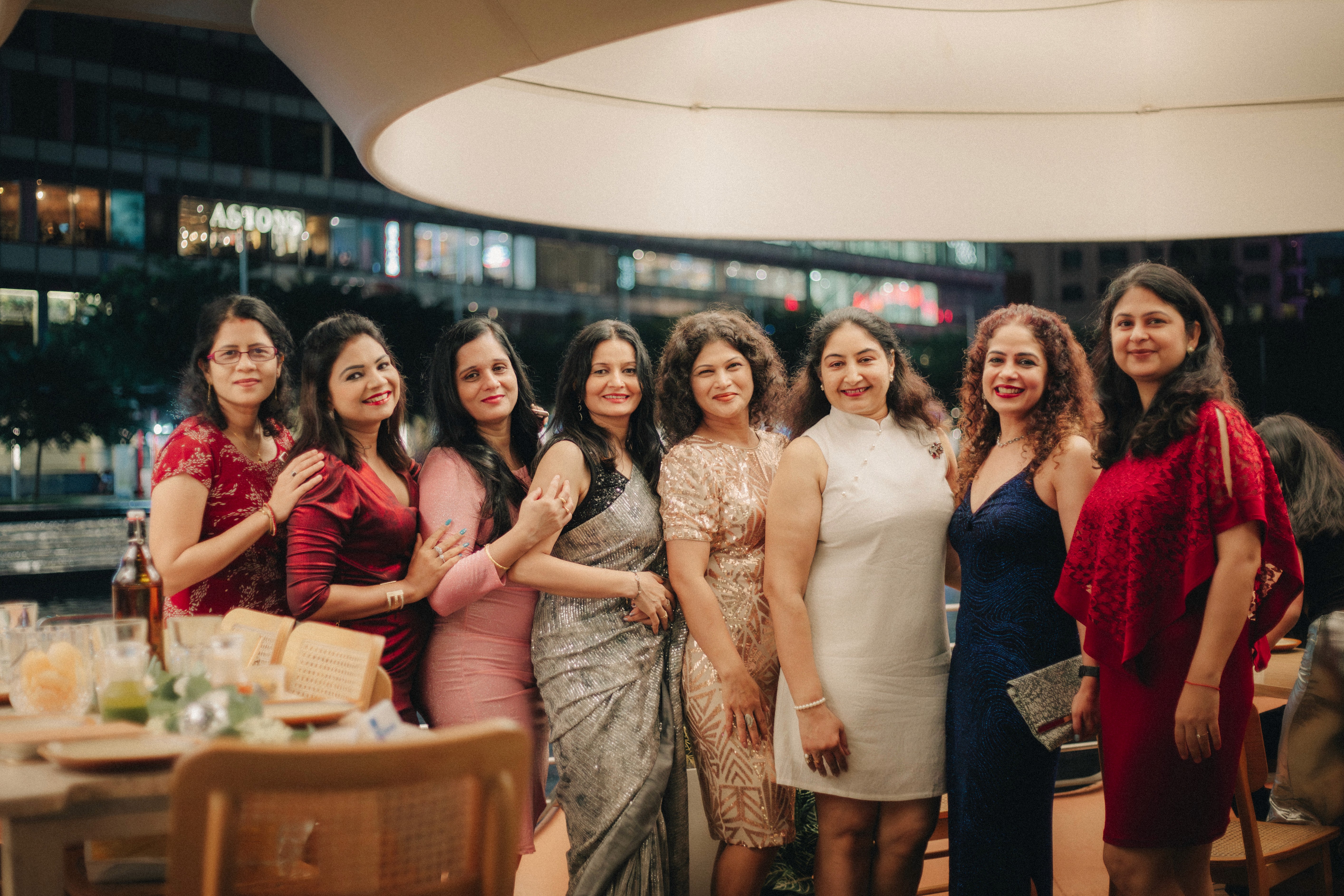 Large group photo of women celebrating an Indian marriage anniversary in Clarke Quay.