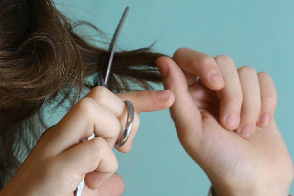 Extreme Frugality - Cut Your Own Hair - Woman cutting her own hair