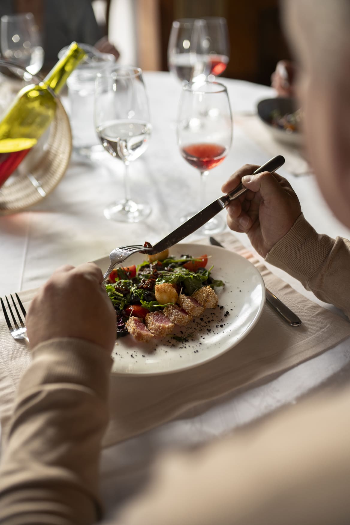 a plate of food on a table with a glass of wine