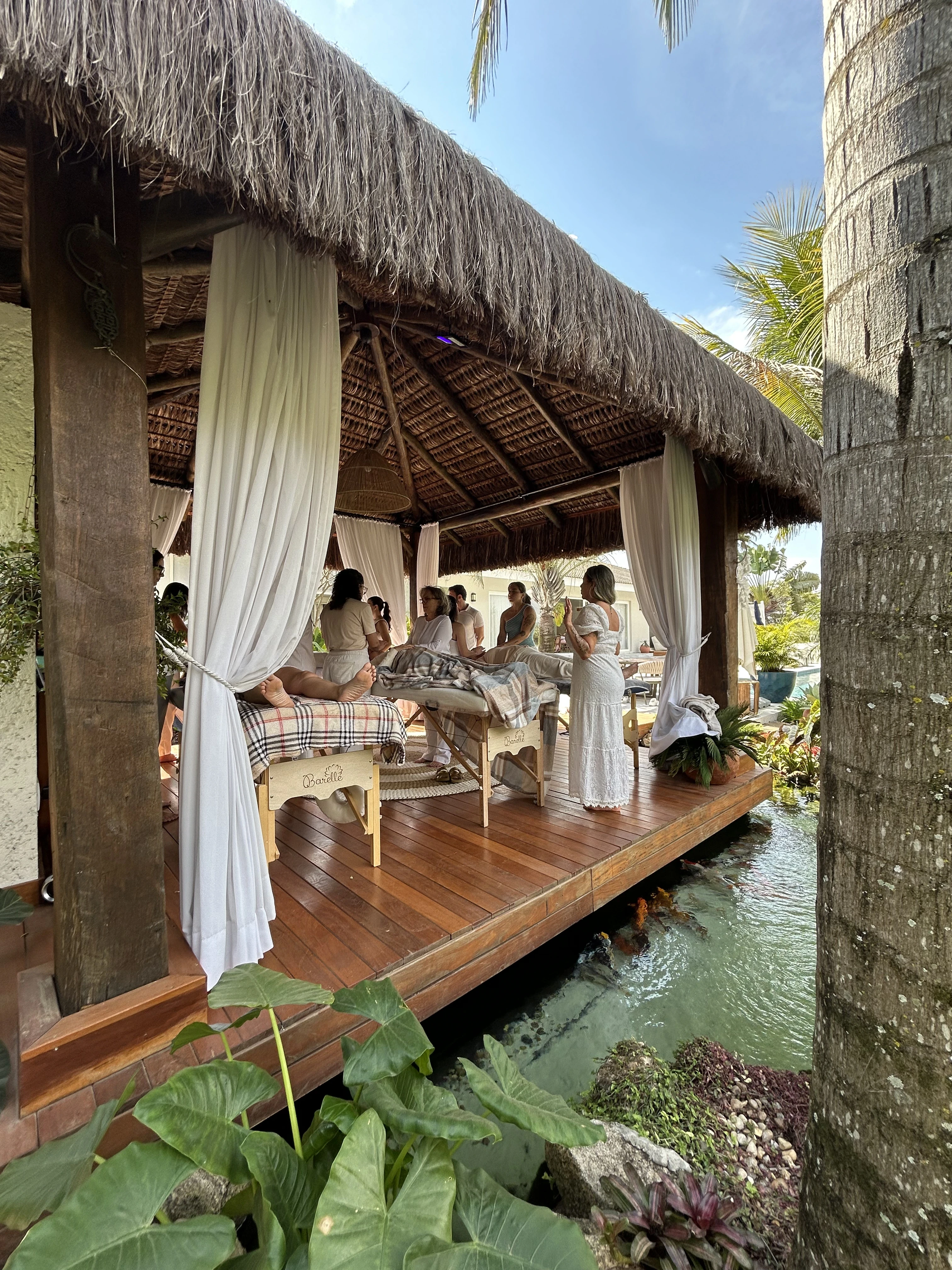 A woman receives a relaxing energy healing in a serene setting with soft lighting.