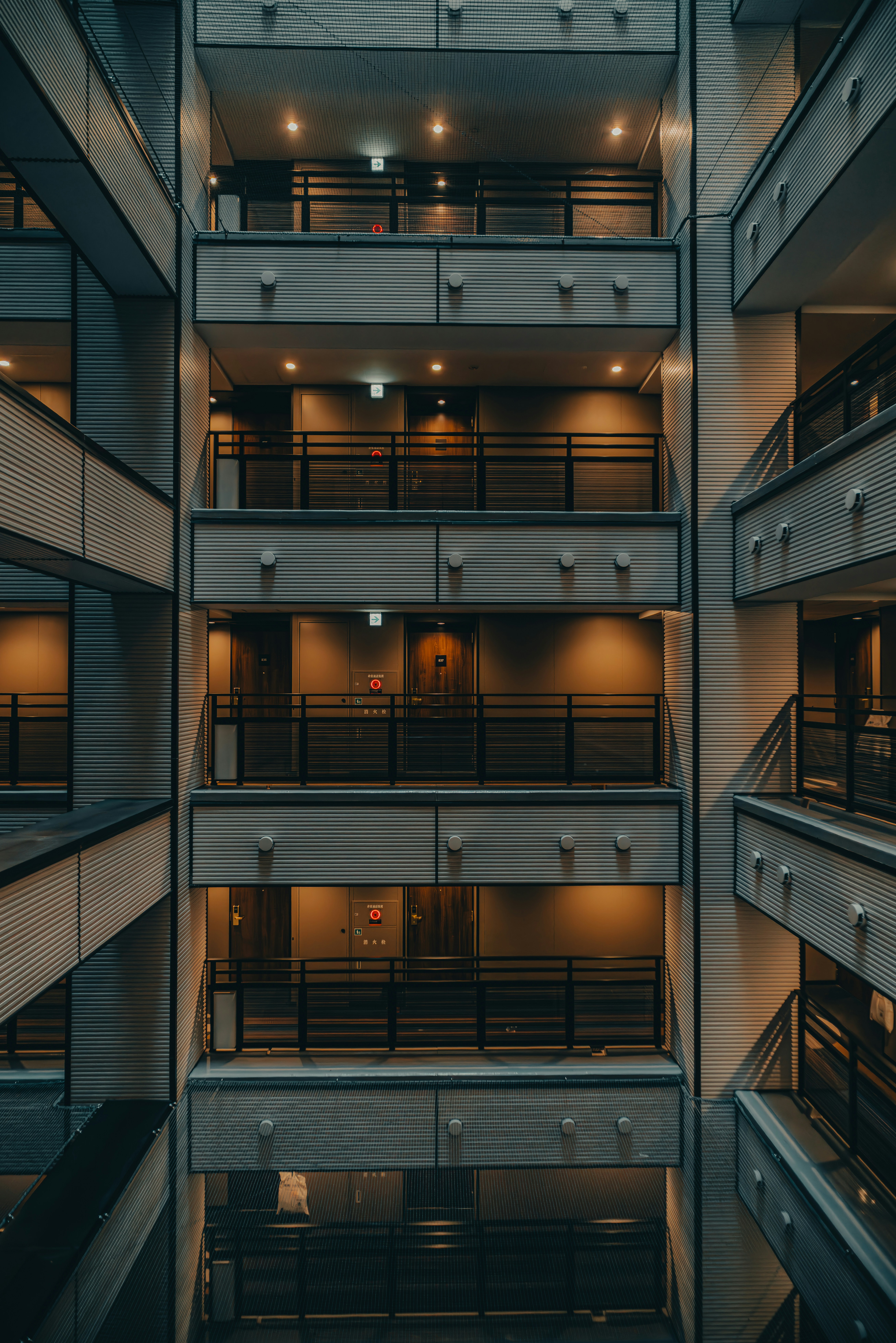 Modern apartment building balconies with illuminated doors