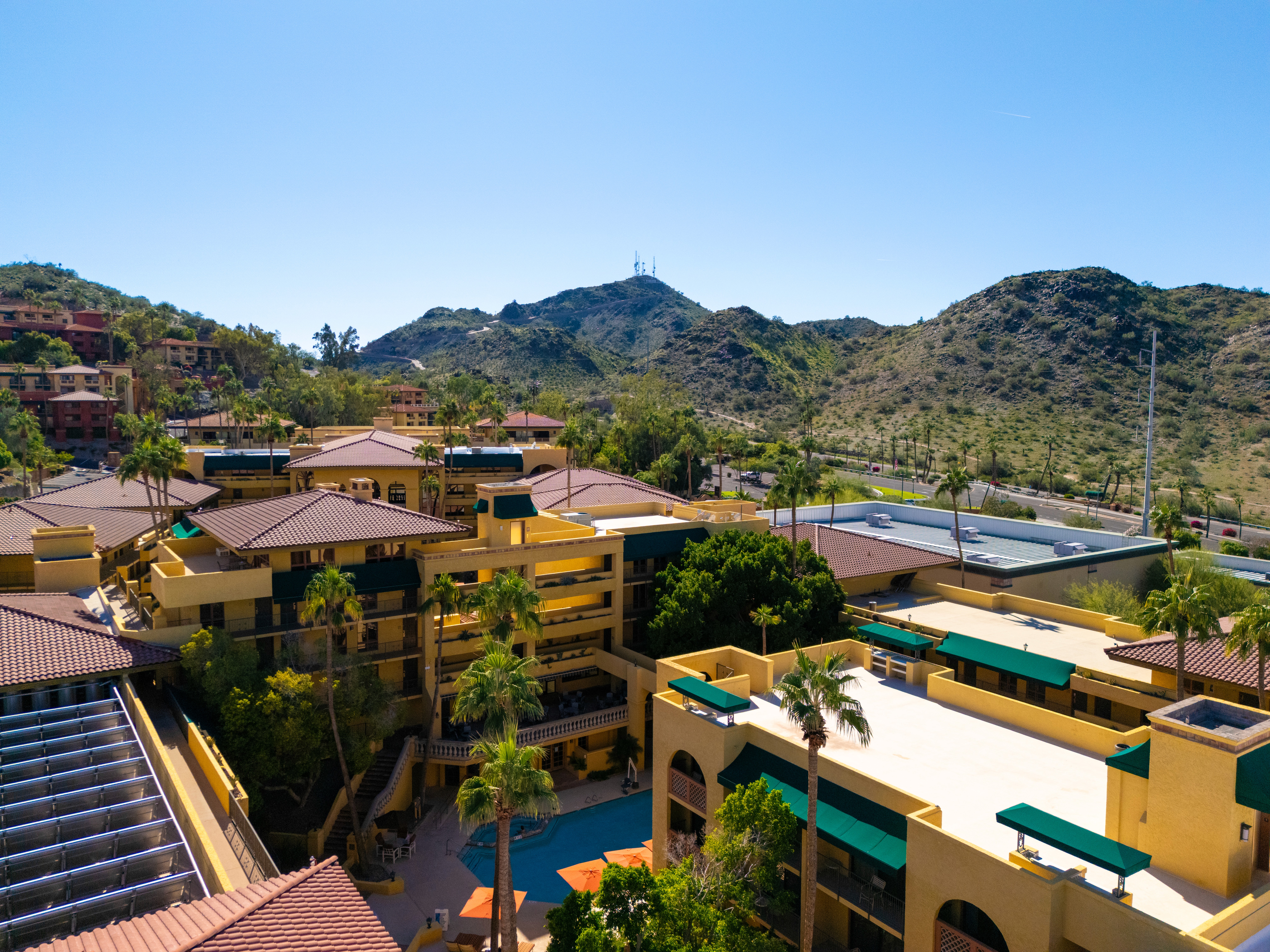 Man and woman working side by side at a desk, both focused on their laptops.