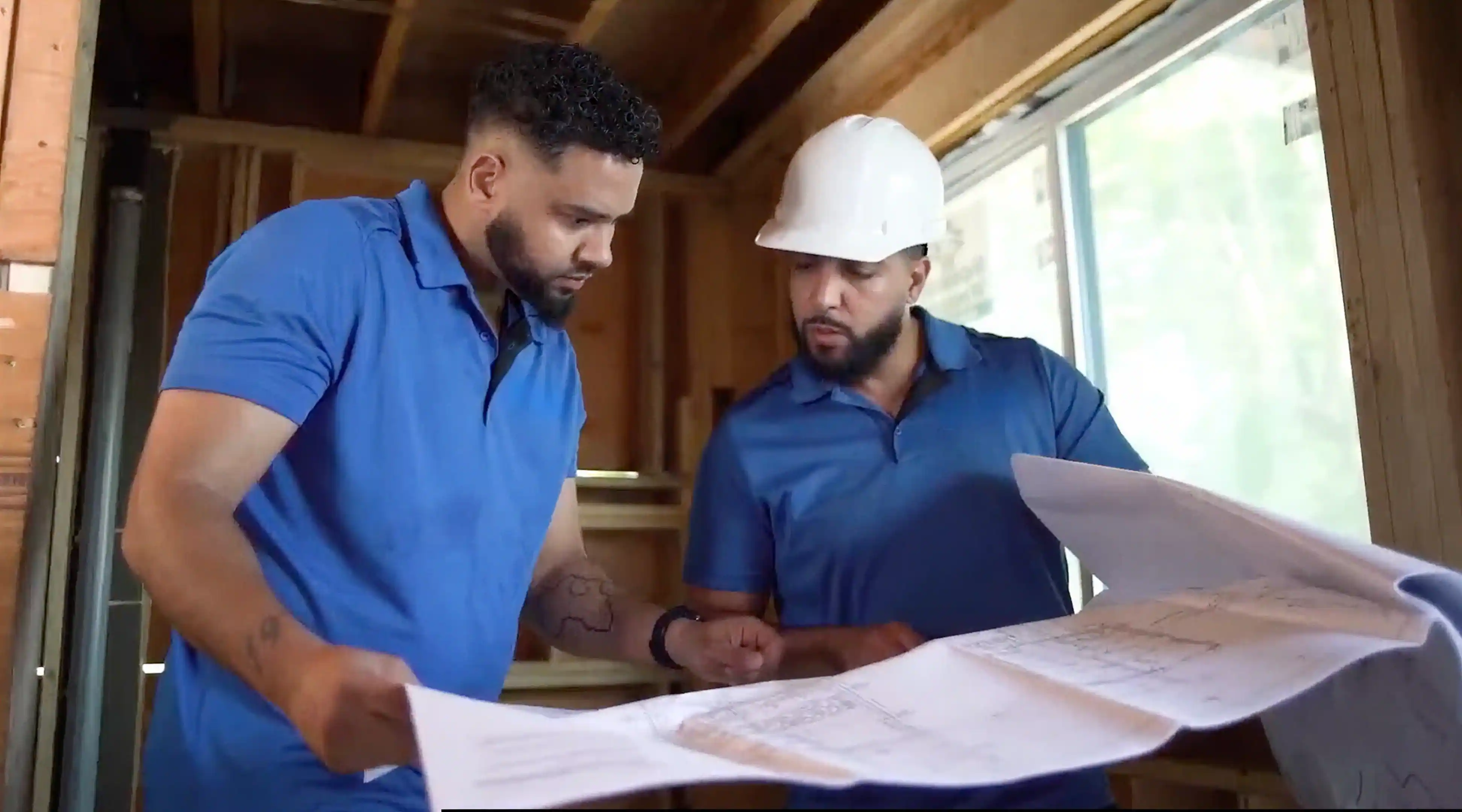 Project manager reviewing construction plans during a home warranty inspection