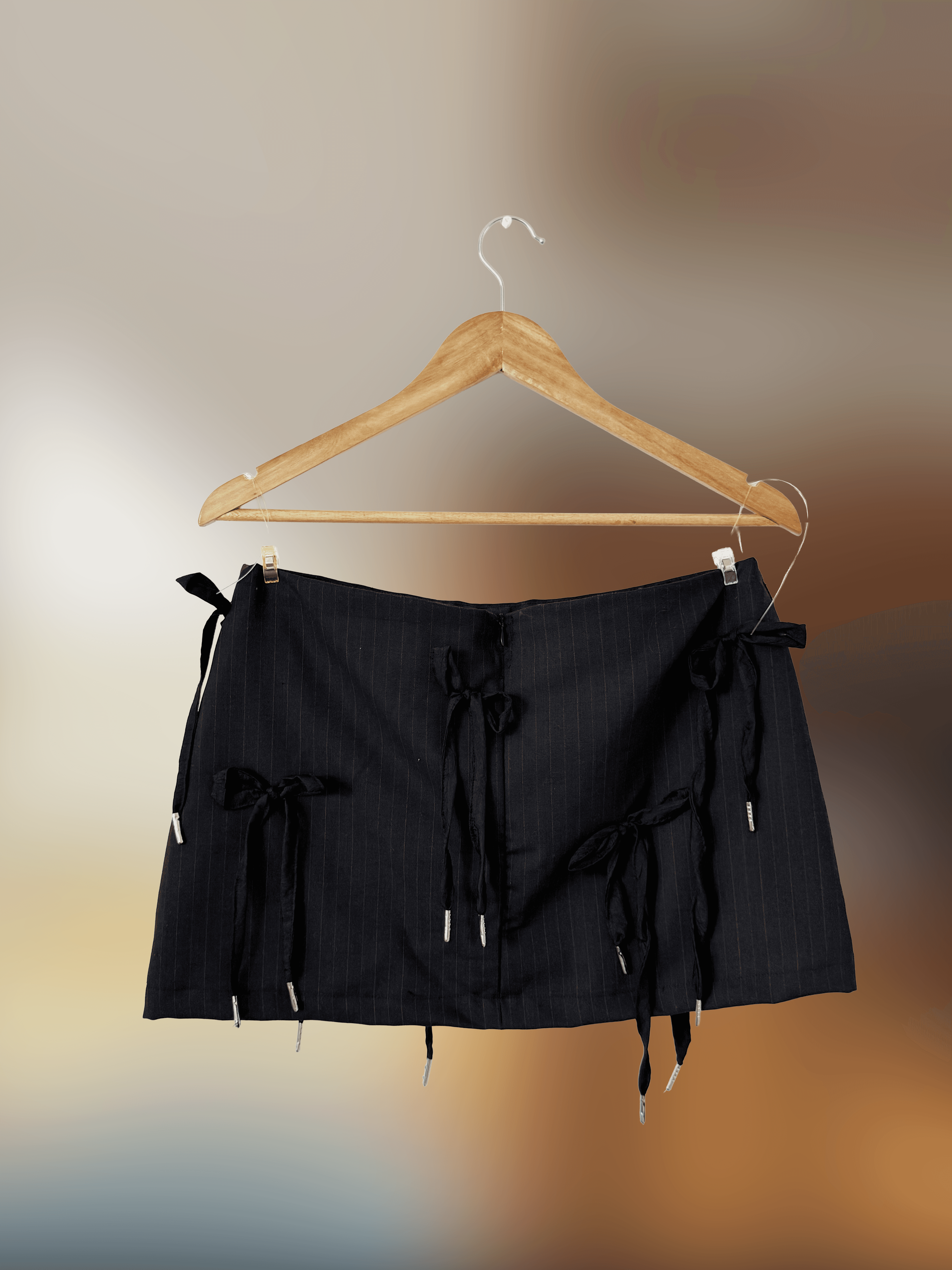 Back of mini black pinstripe skirt with tie detailing