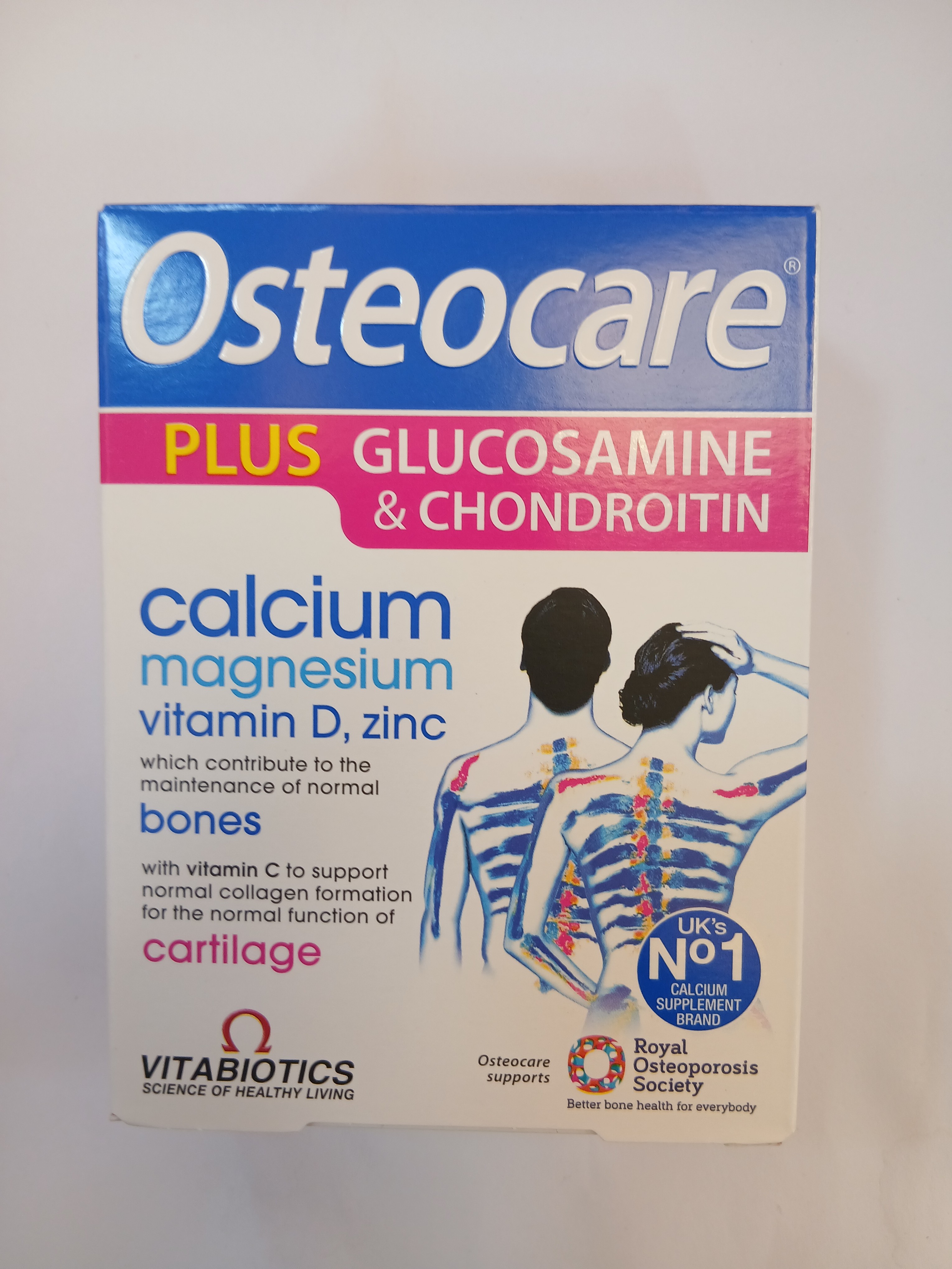 A white cardboard box packaging displays a blue and pink label featuring an illustration of a human skeleton with highlighted bones, listing ingredients such as calcium, magnesium, vitamin D, zinc, glucosamine, and chondroitin.