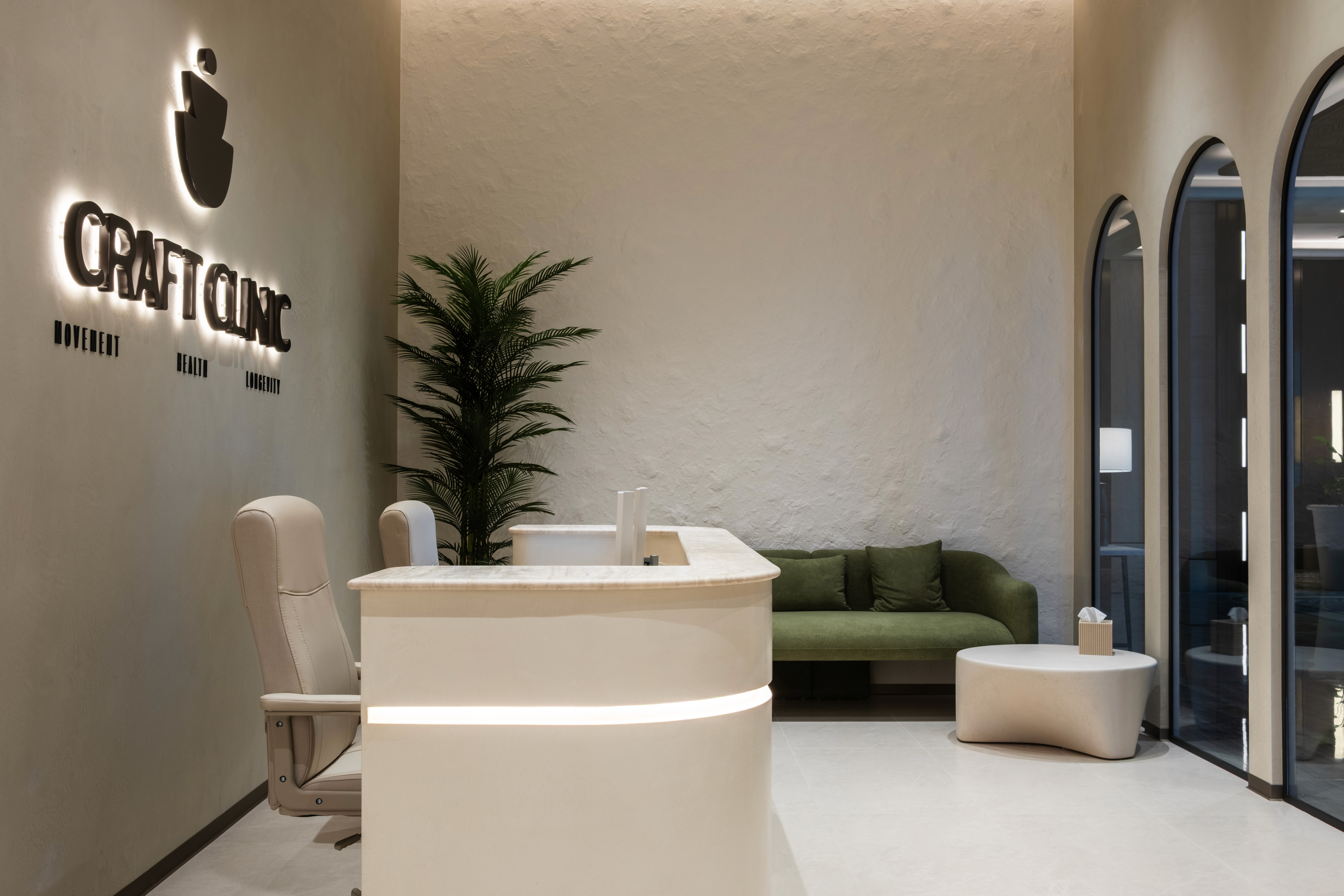 High-rise luxury fitness floor with dark walnut slatted ceiling, fluted column details, full-length city-view windows, and a curated mix of strength and cardio equipment
