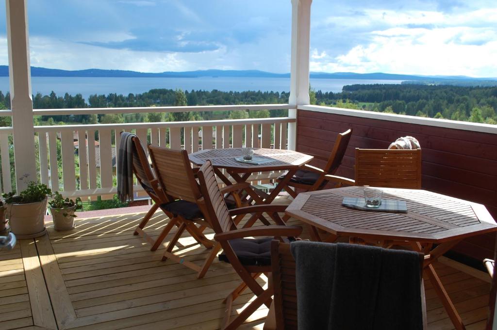 A couple dances closely, showcasing a flowing green dress, against a soft, blurred background of other guests.