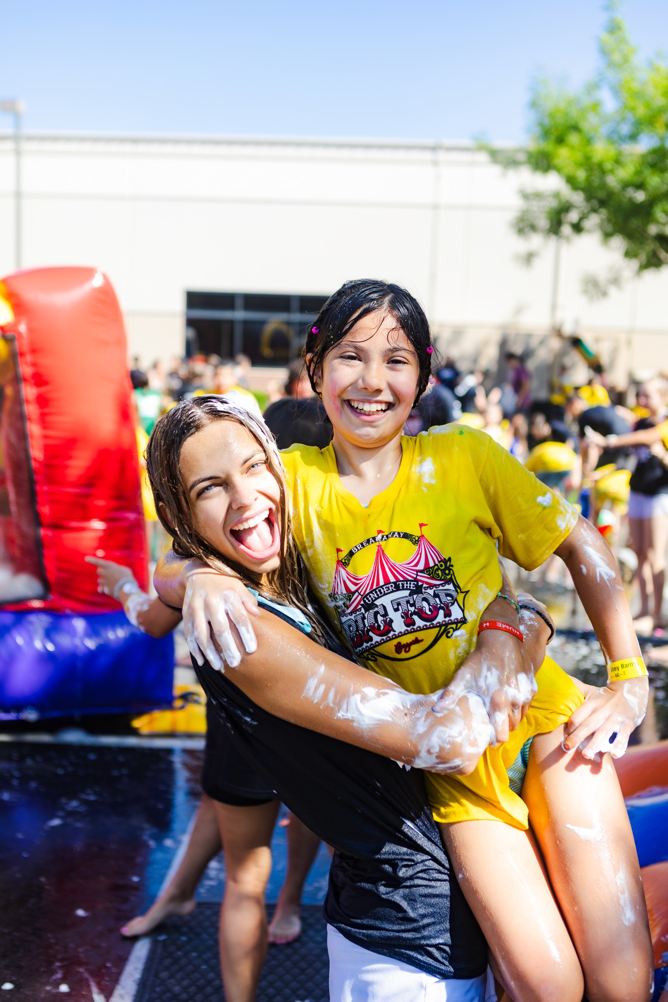 two people looking at a tablet and smiling